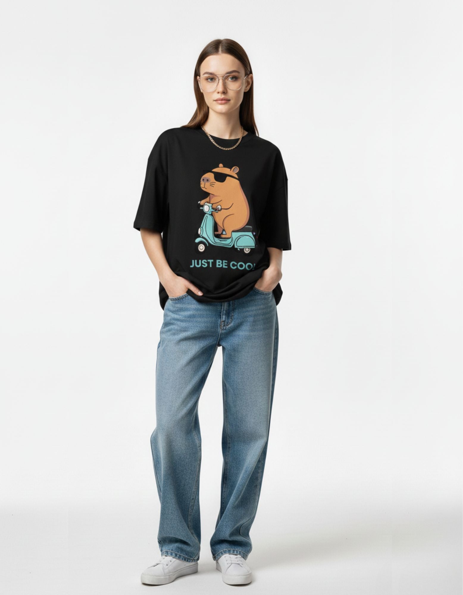 Front view of a premium black oversized t-shirt for women featuring a "Just Be Cool" capybara graphic, perfect for Indian streetwear style.