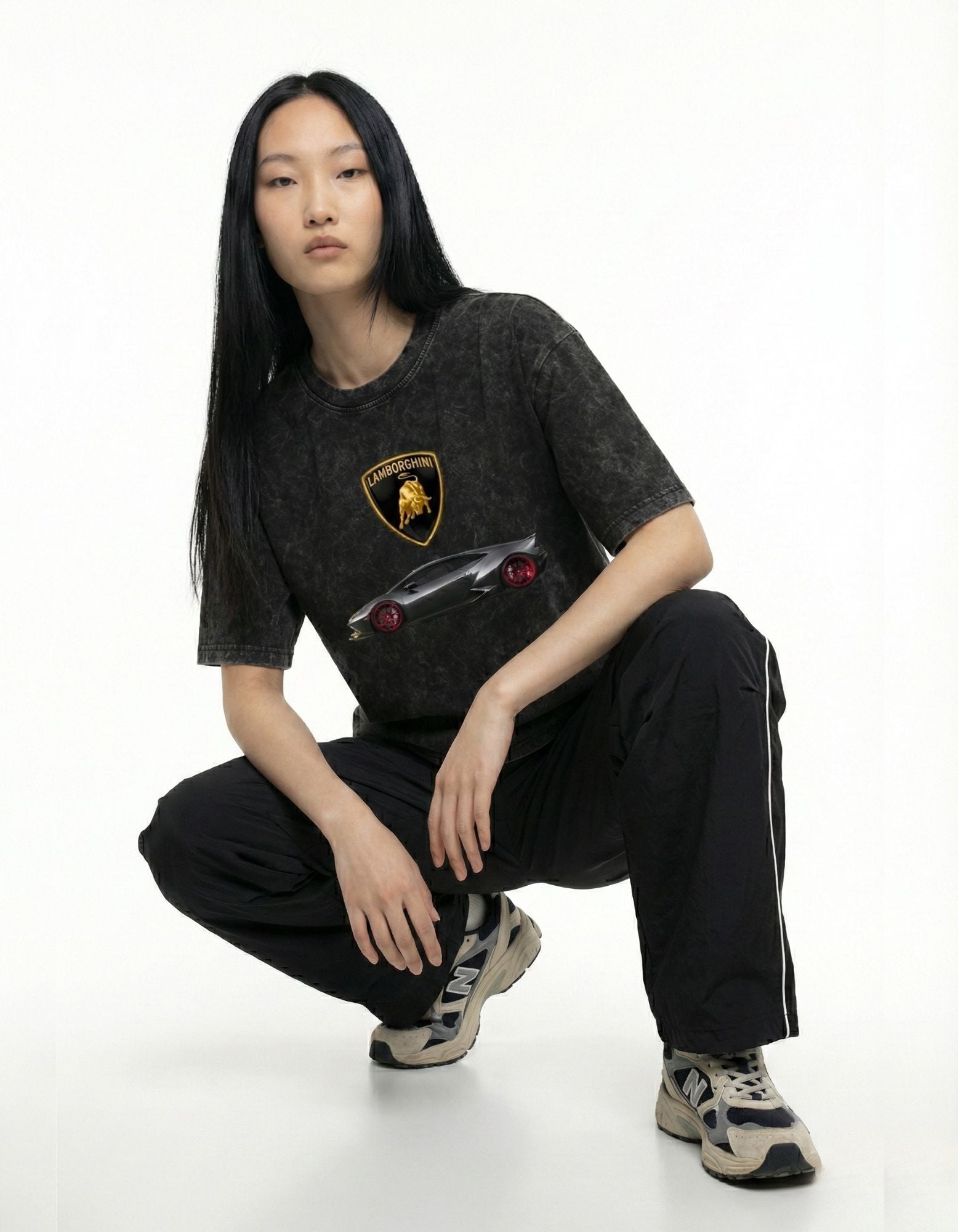 Simple back view of a high-quality washed black graphic t-shirt, showing the premium fabric texture and oversized drape.