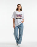 White oversized t-shirt for girls featuring "Just a girl who loves Anime and Kpop" with pink manga eyes graphic.