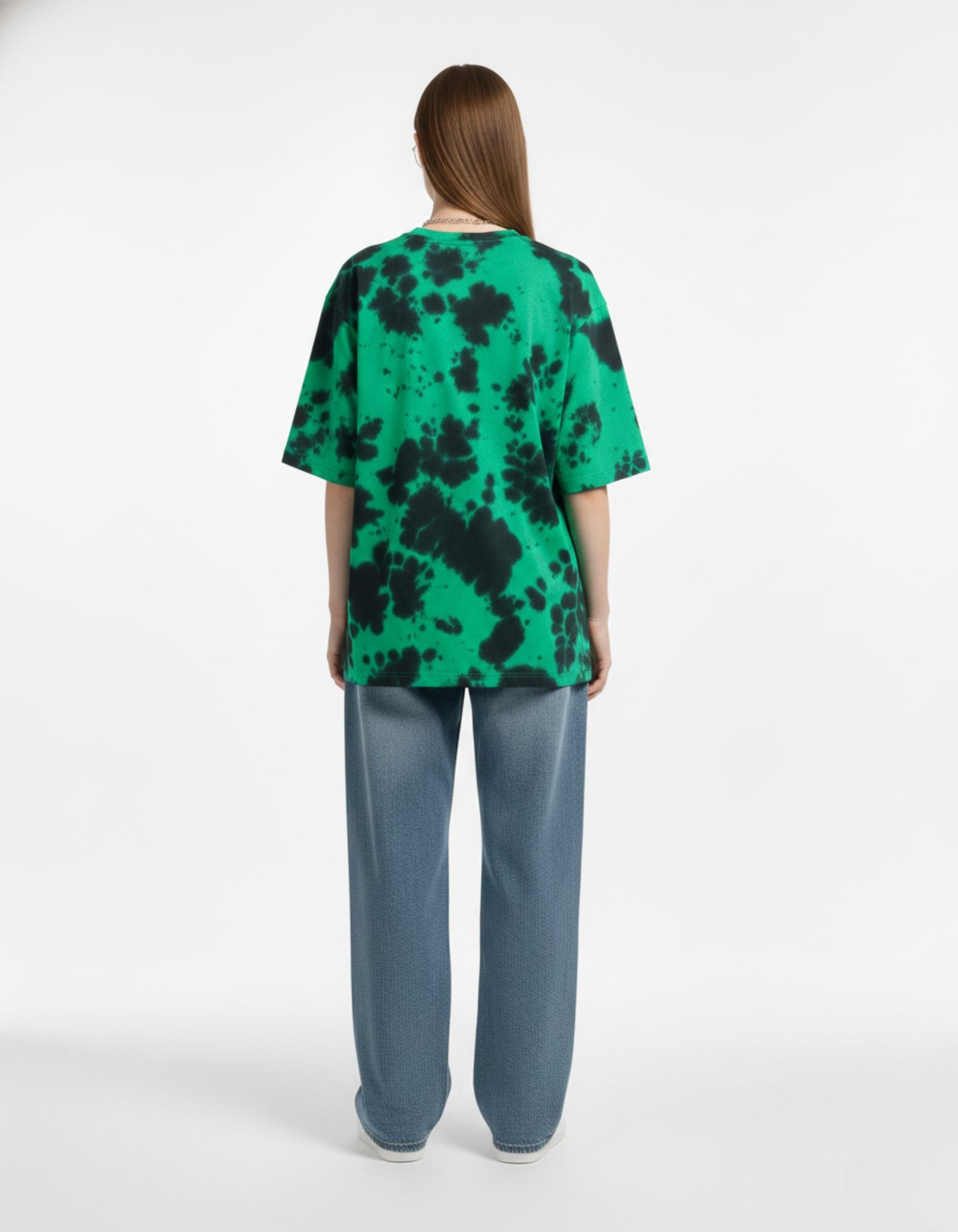 "Back view of green and black tie-dye oversized t-shirt, showing the unique patterns and relaxed drop shoulder fit."