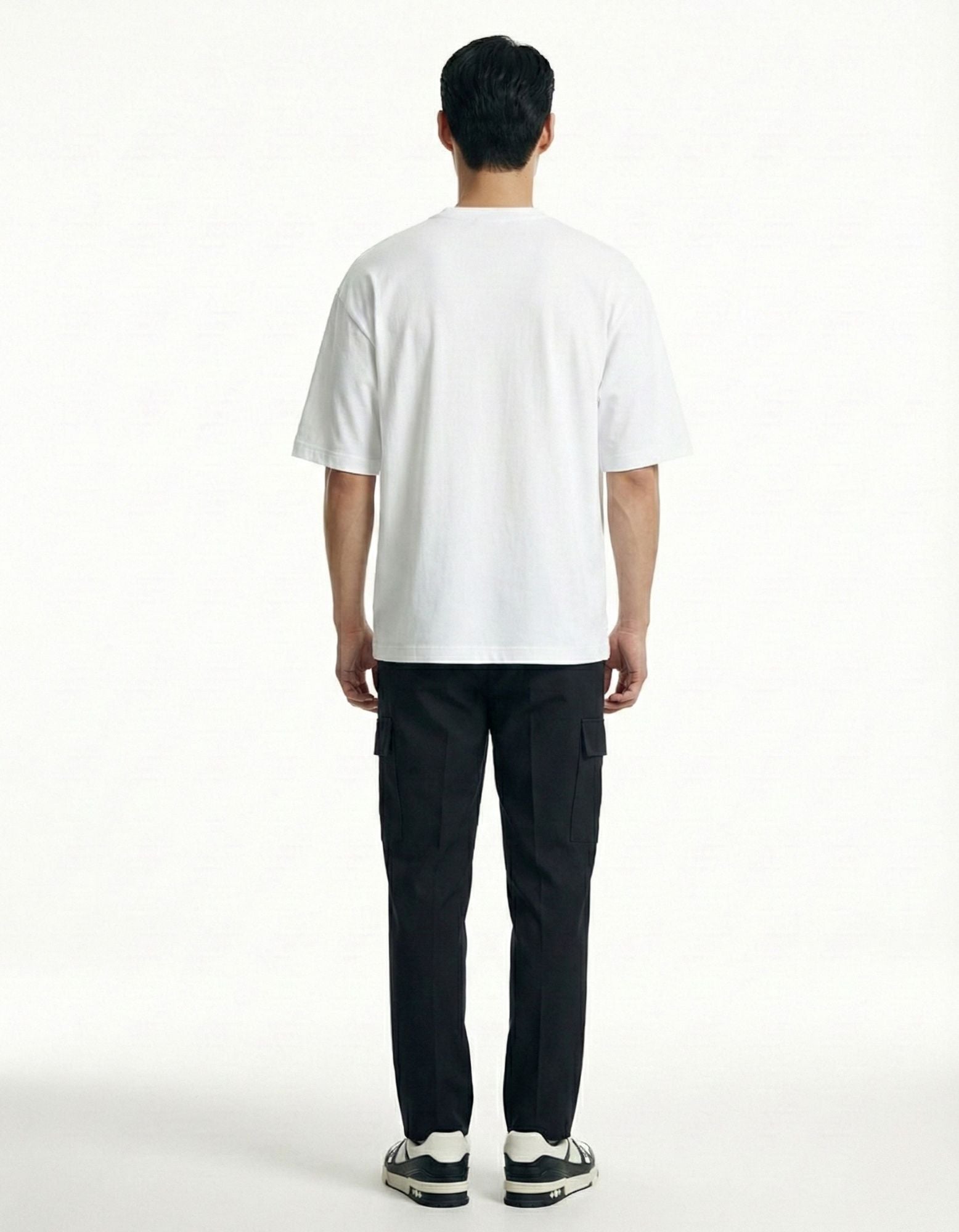 "Back view of a plain white oversized streetwear t-shirt for men, showing the minimal aesthetic and fit."