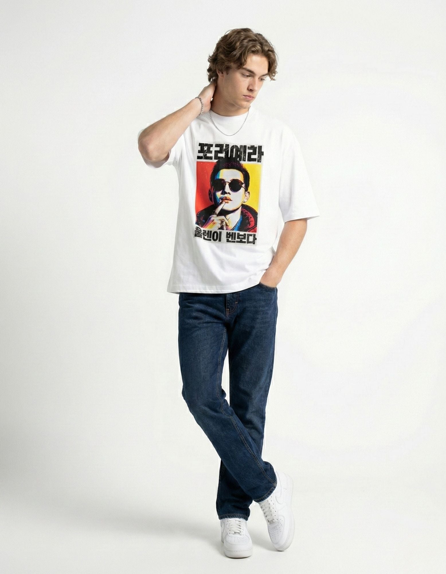 "Stylish man posing in a white baggy t-shirt with Korean character design, premium cotton streetwear."