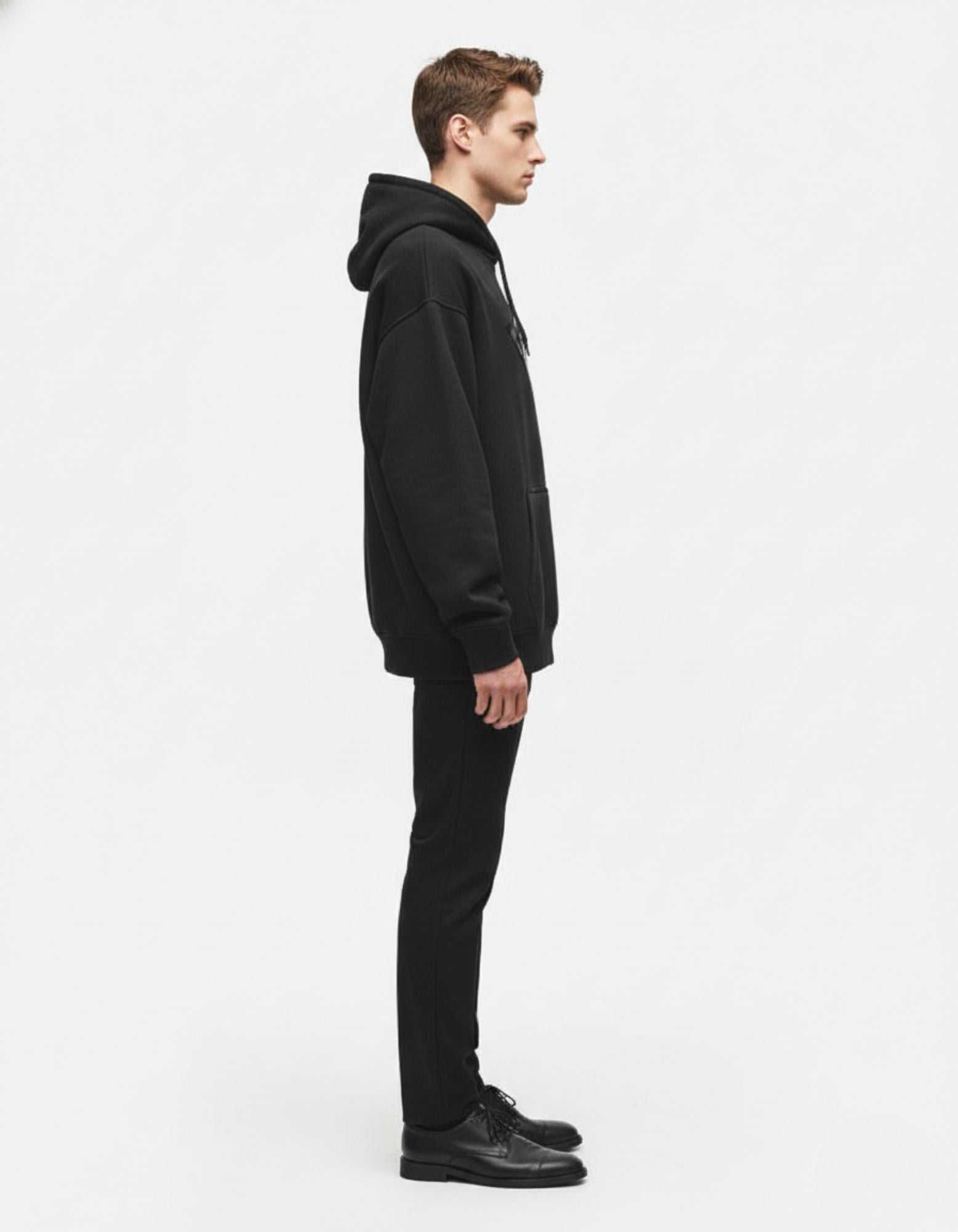 Side profile of a heavyweight black fleece hoodie by GENZs Fashion, highlighting the high-quality fabric and comfortable oversized drop-shoulder fit.