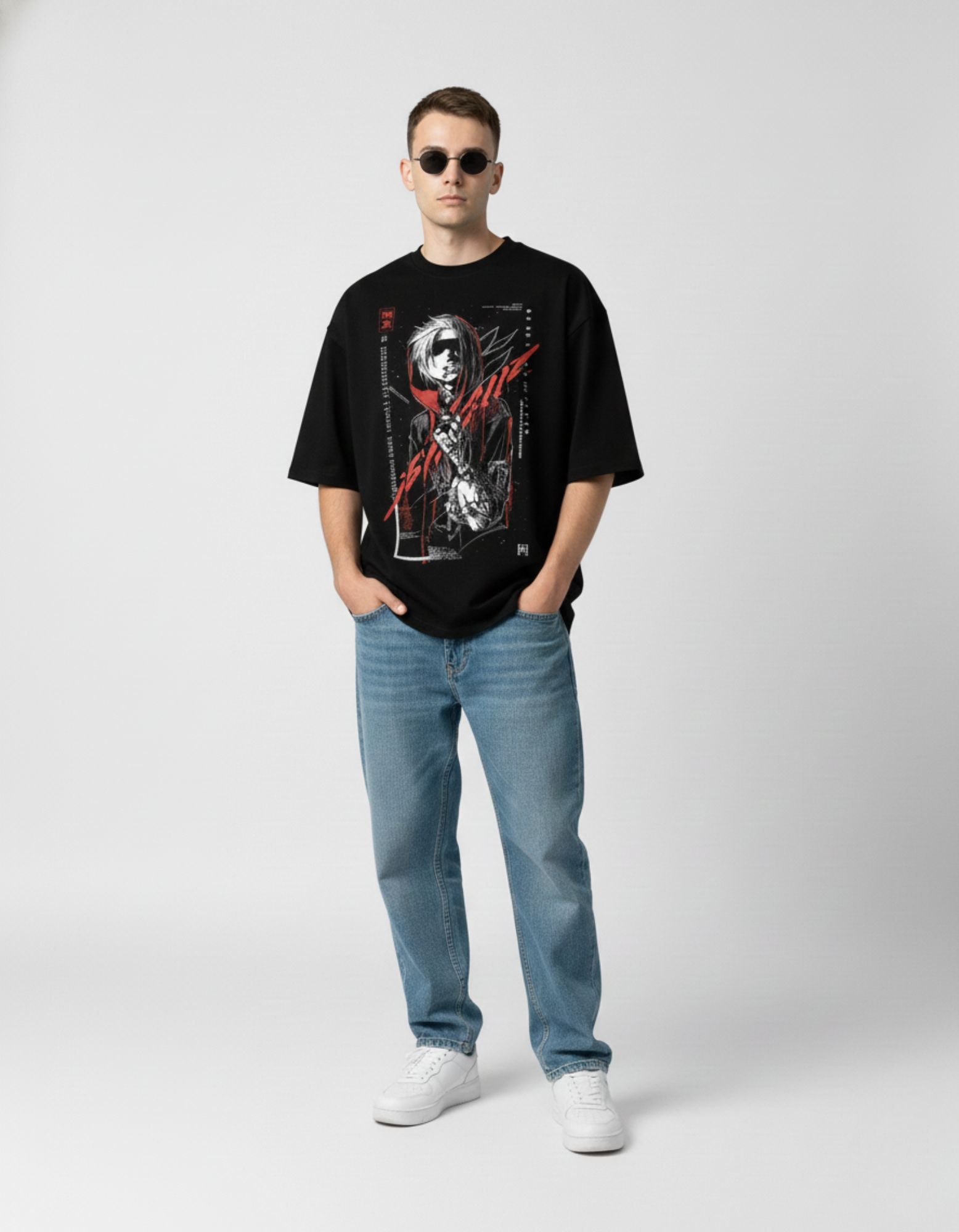 Male model wearing a black oversized streetwear t-shirt featuring a red anime character graphic and Japanese text.
