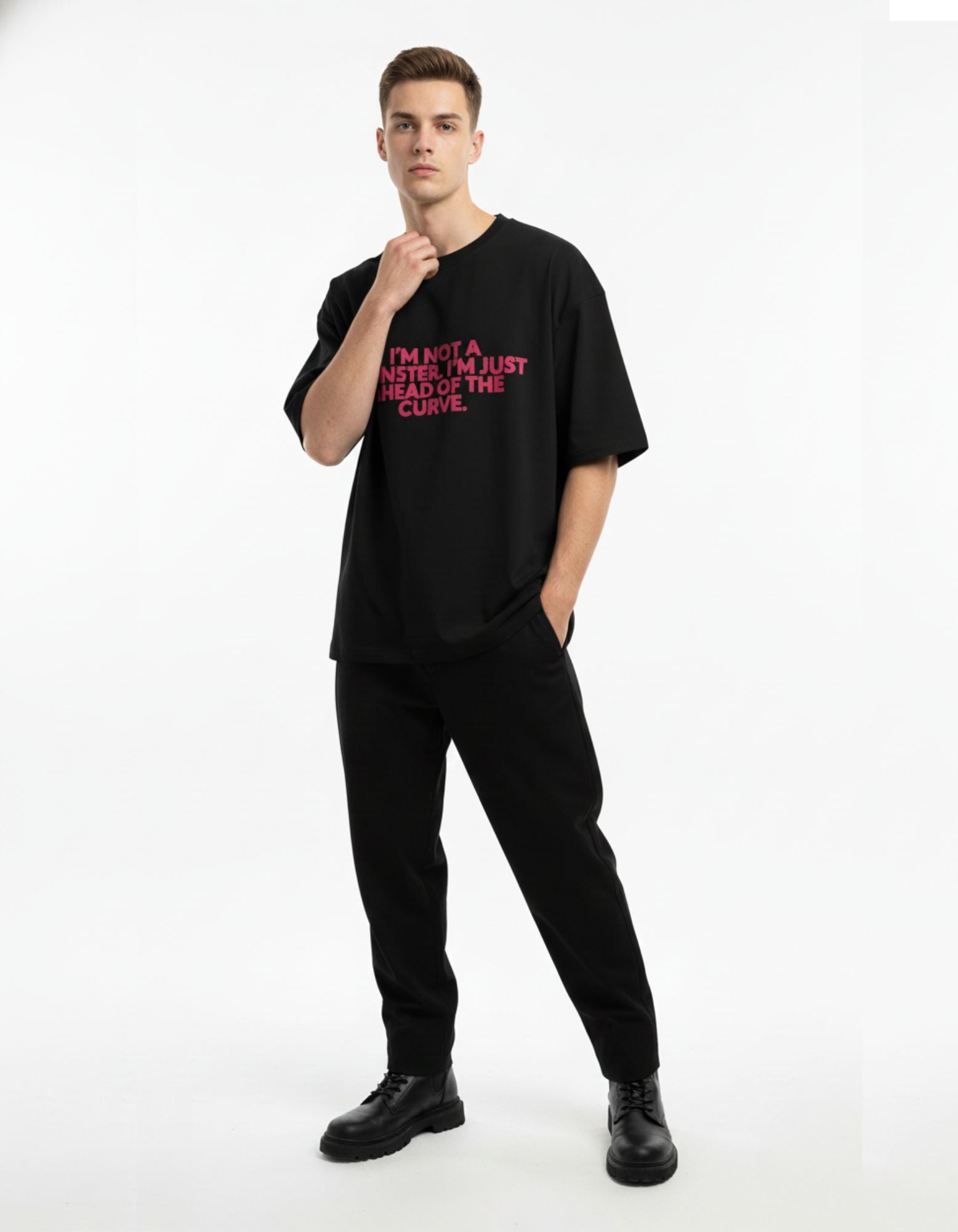 Side profile of man wearing black oversized t-shirt with pink graphic print, high-quality streetwear for men in India.