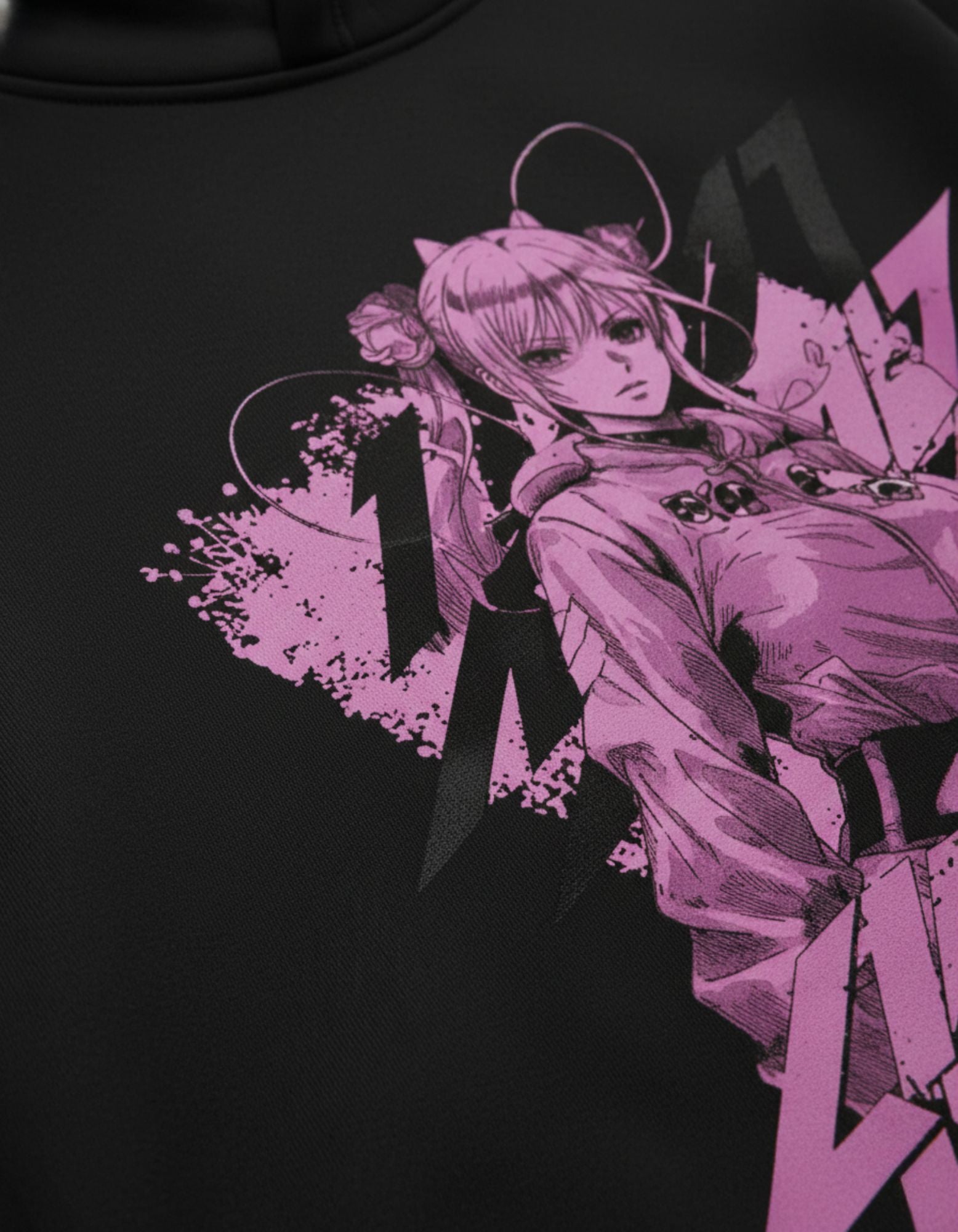 Close up of black oversized hoodie showing detailed anime graphic print
