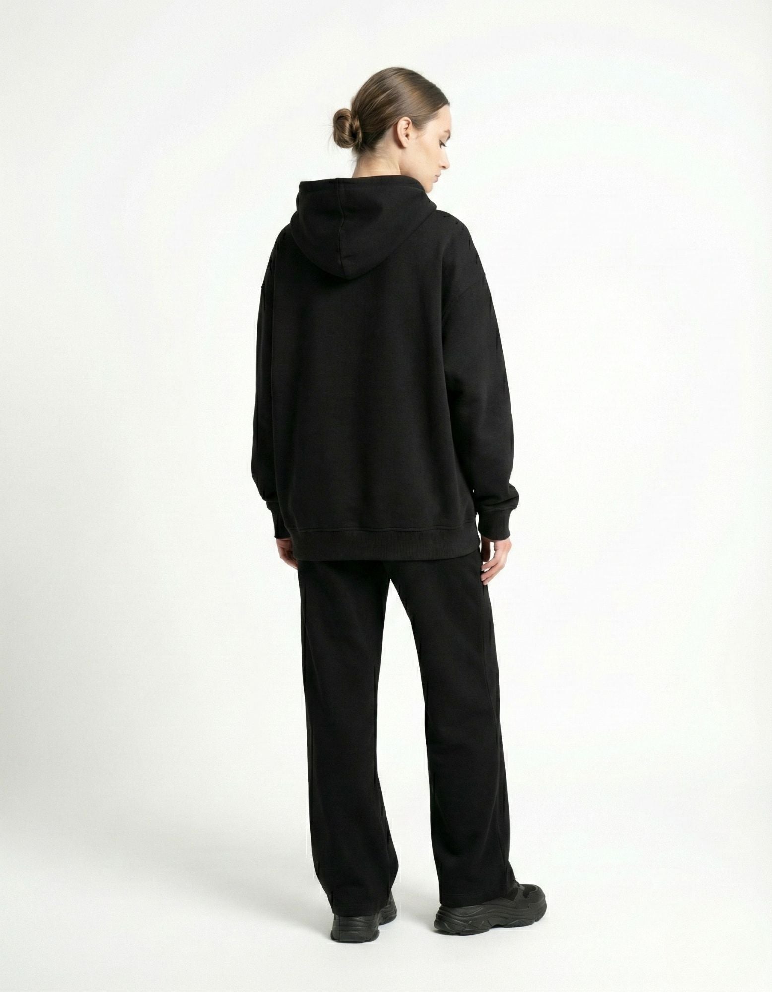Rear view of a woman wearing an oversized black hoodie from GENZs Fashion, highlighting the comfortable fit and premium fabric.