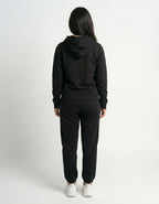 Back view of a high-quality black oversized hoodie and matching joggers, showcasing the fit for urban streetstyle.