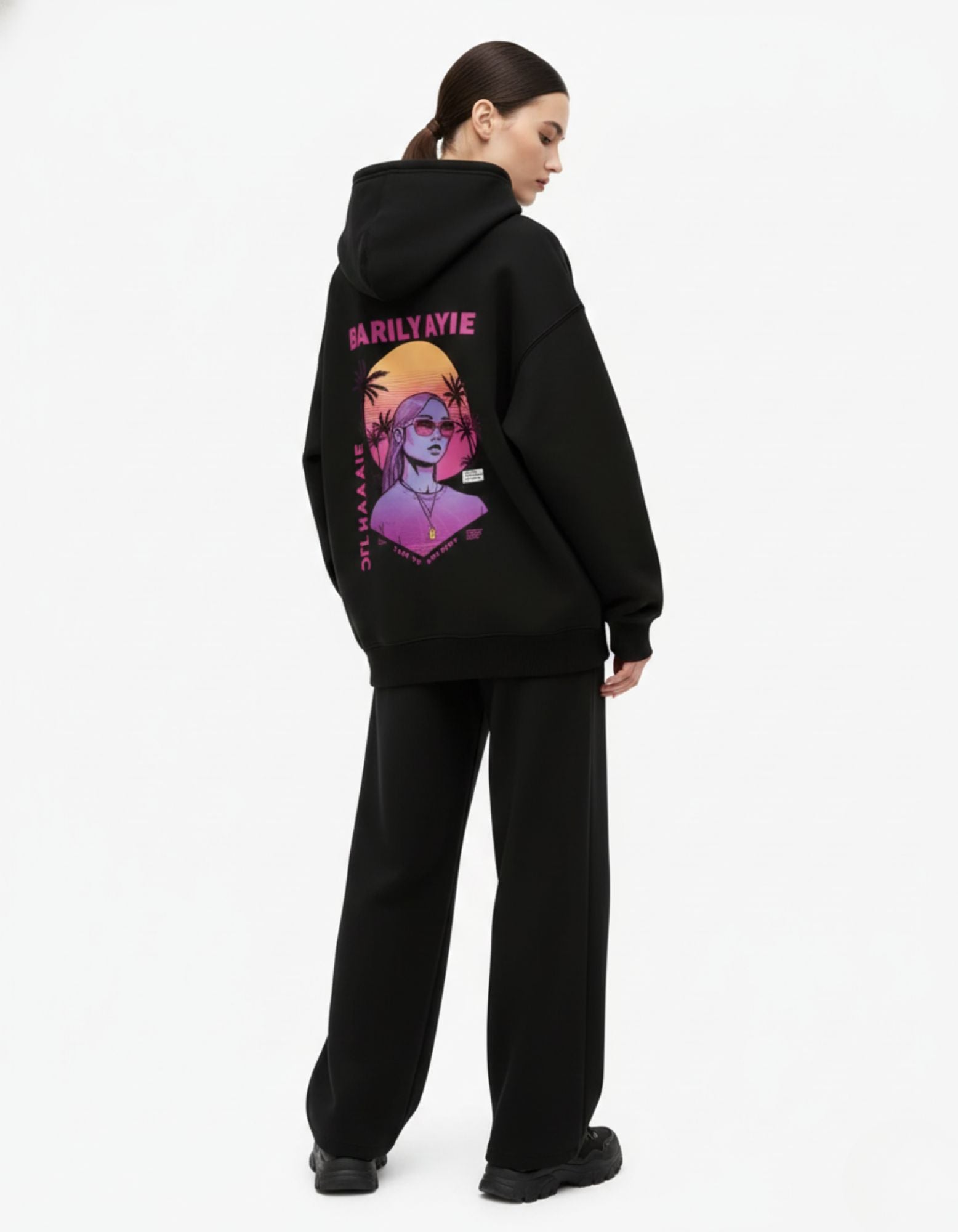 Back view of black oversized hoodie featuring anime graphic print