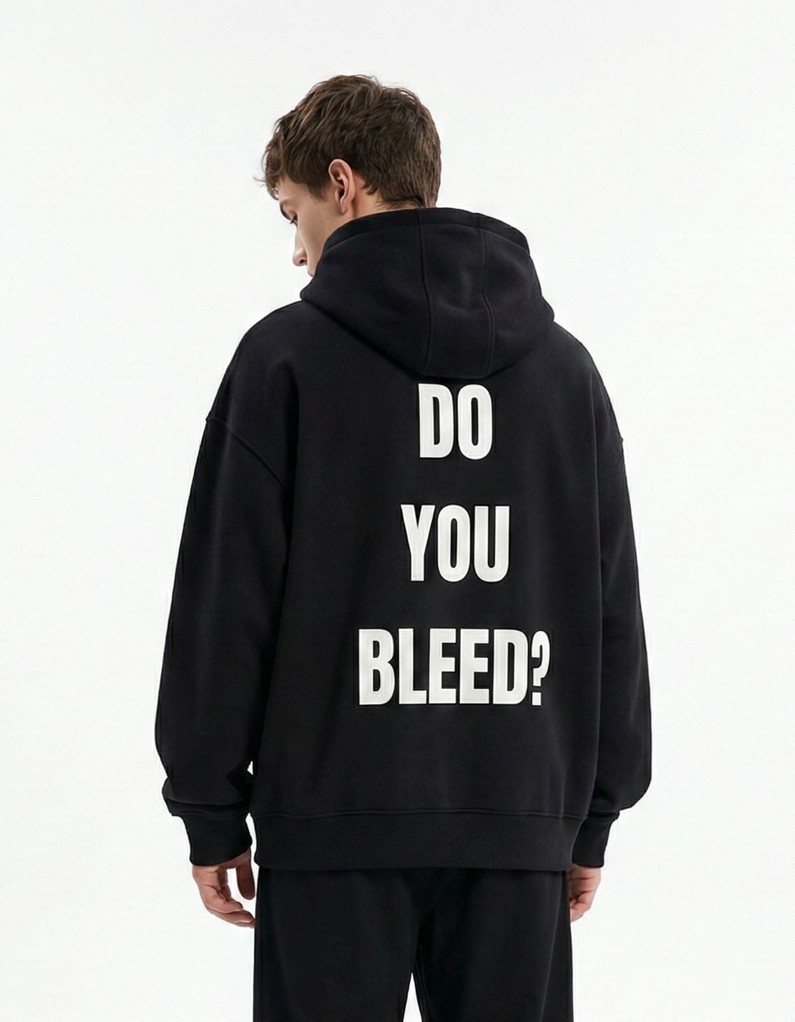 Back view of a black oversized hoodie with high-quality white puff print text reading "DO YOU BLEED?"