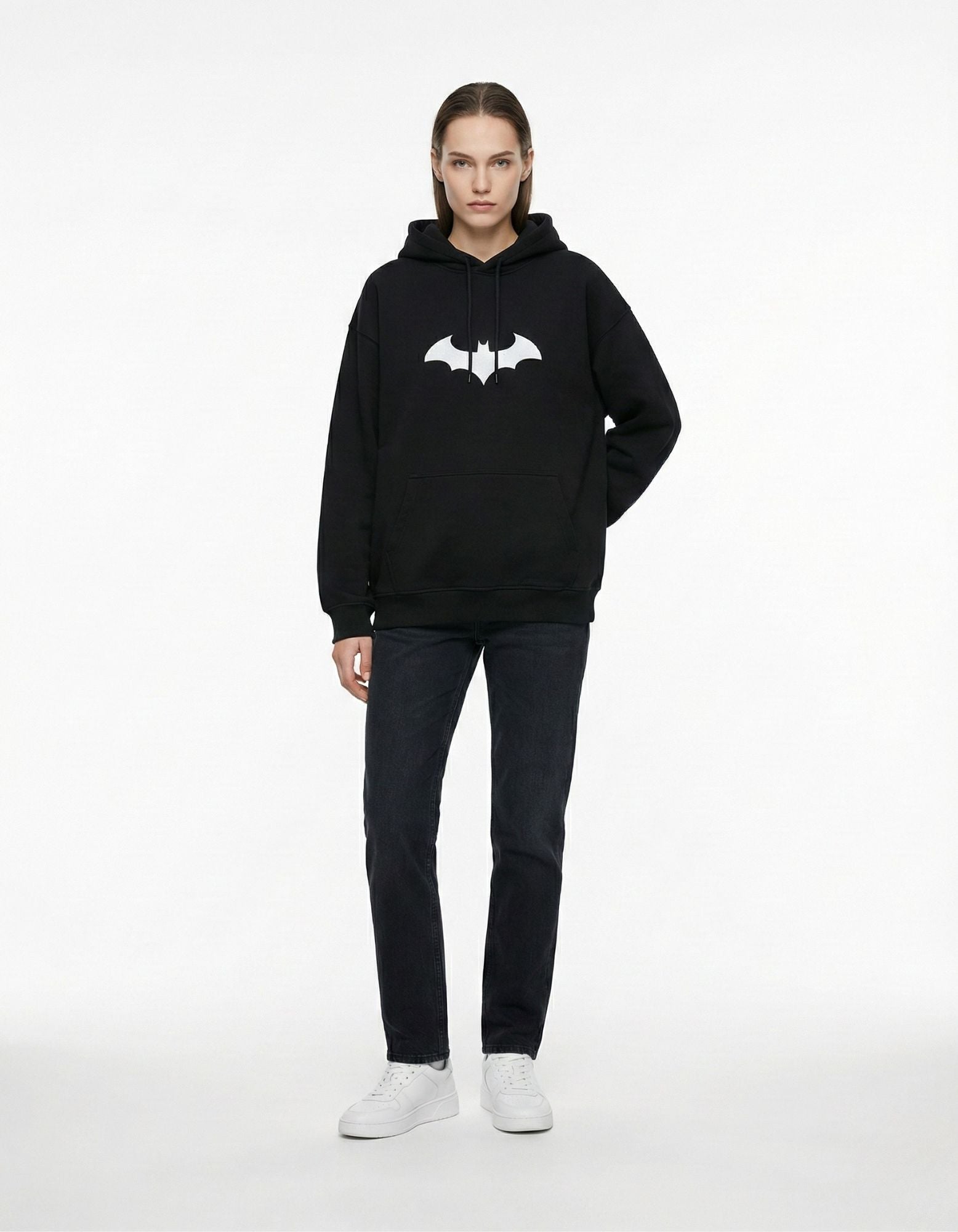 Female model showcasing the unisex oversized fit of the black Batman logo hoodie from GENZs Fashion streetwear collection.