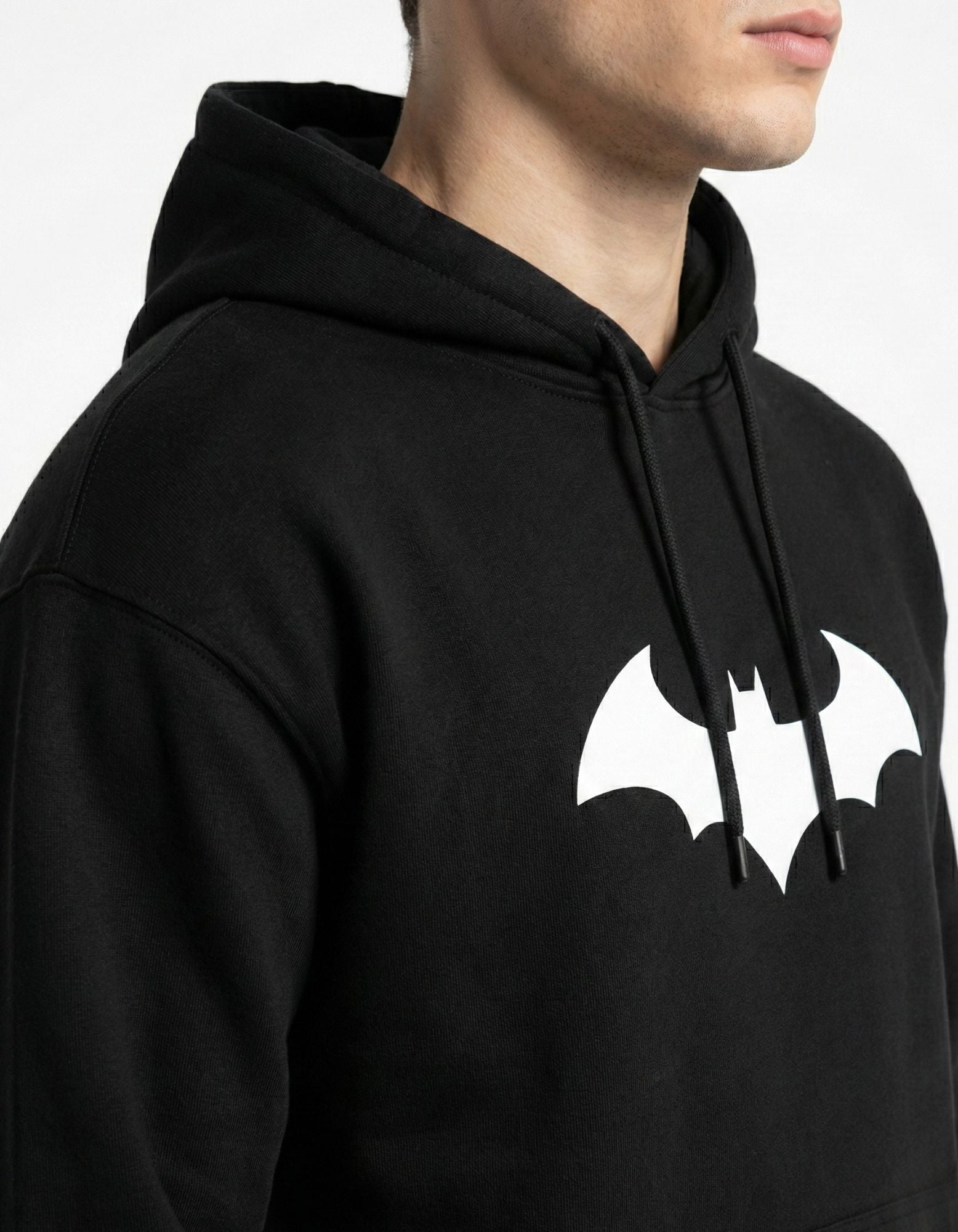 Close-up of premium 400 GSM heavy cotton fabric and white bat logo on the GENZs Fashion black oversized hoodie.