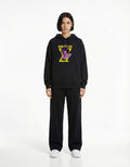 Front full view of black oversized hoodie with bold graphic print
