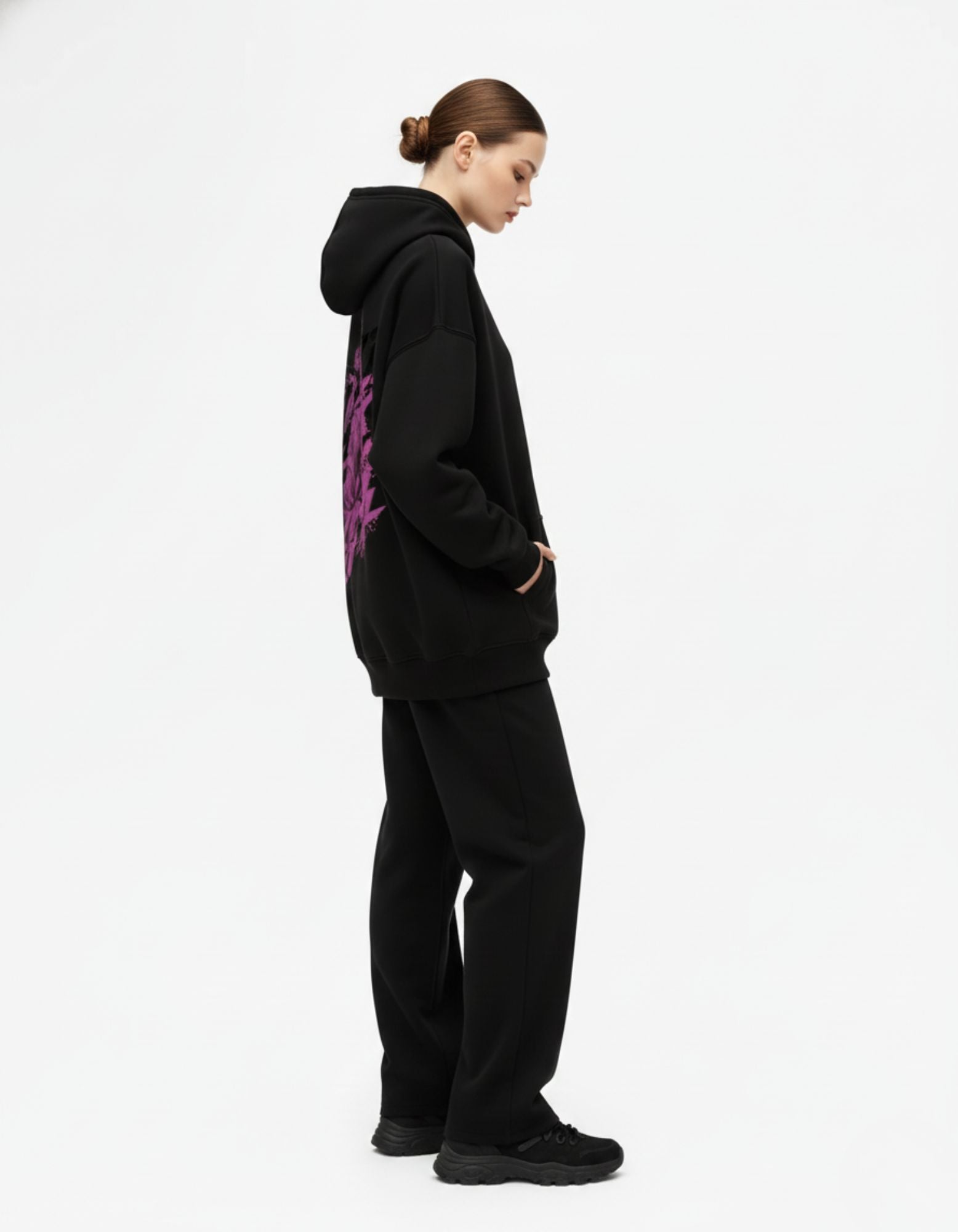 Side view of black oversized hoodie showing relaxed oversized fit
