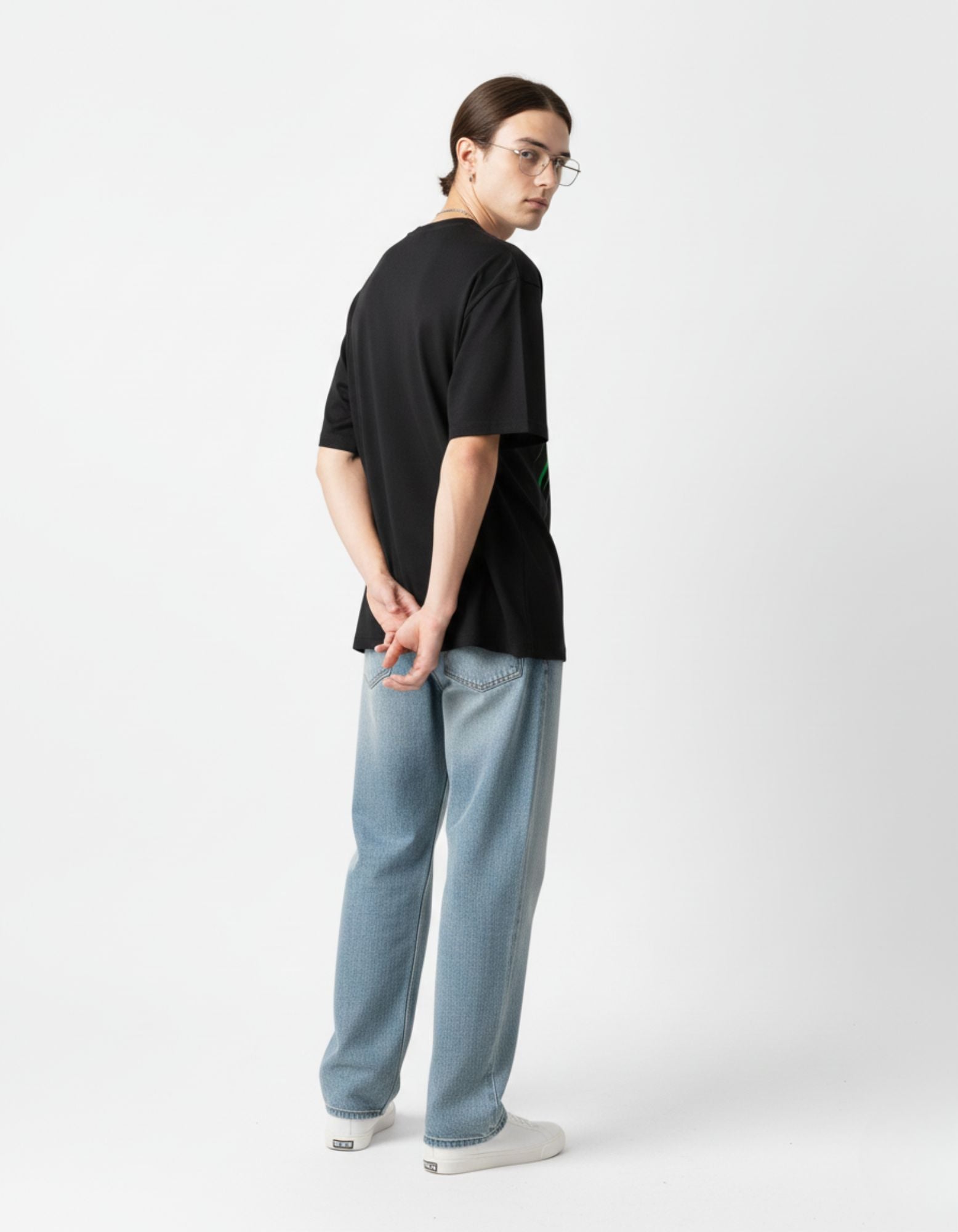 Side view of the GENZY black anime tee, highlighting the baggy streetwear fit and sleeve length.