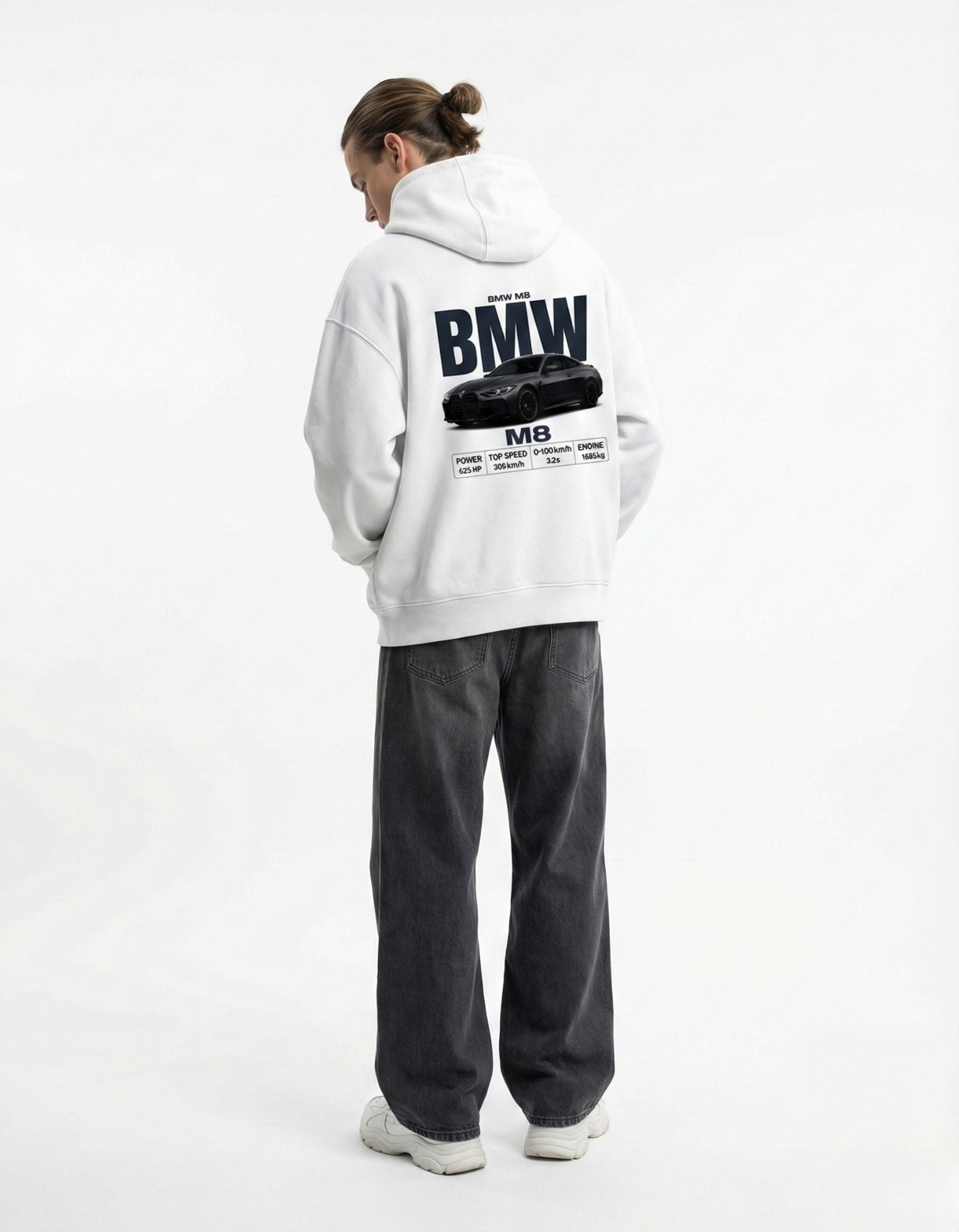 Male model wearing white GENZs Fashion hoodie featuring a detailed BMW M8 back print with car performance statistics.