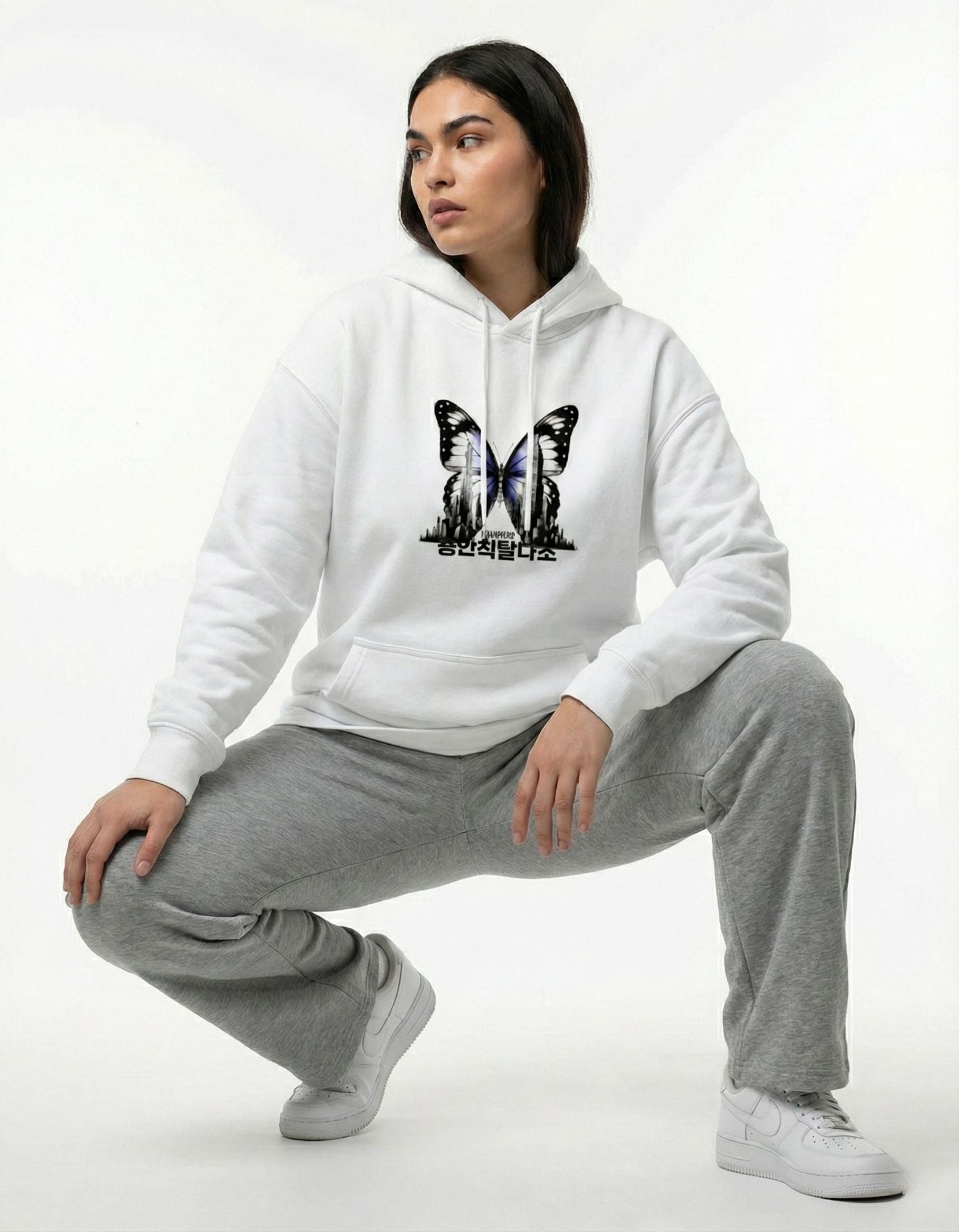 Female model in GENZs Fashion white butterfly graphic hoodie with Korean text, aesthetic streetwear style.