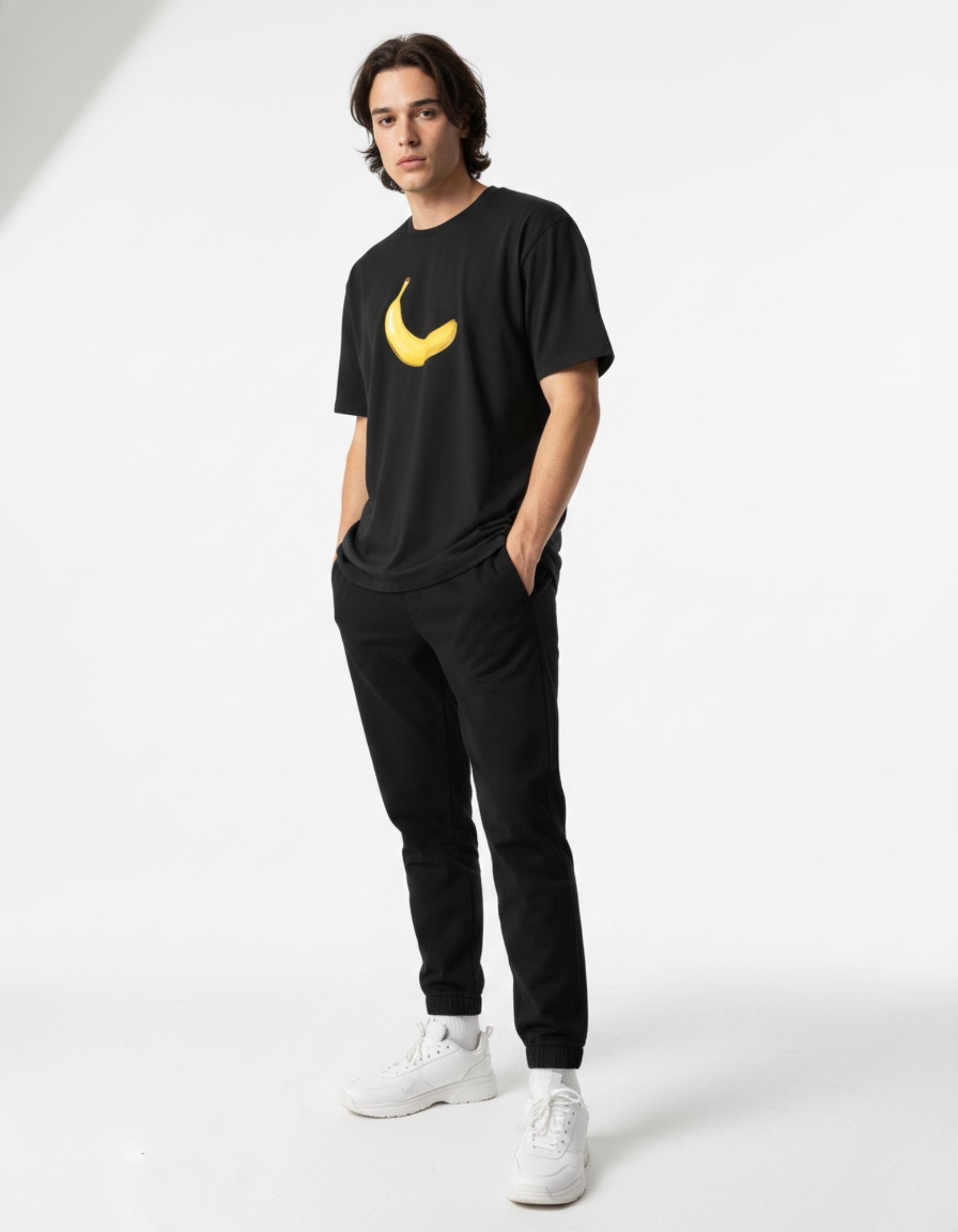 Male model wearing a casual GENZs Fashion black streetwear t-shirt with a yellow banana chest print.