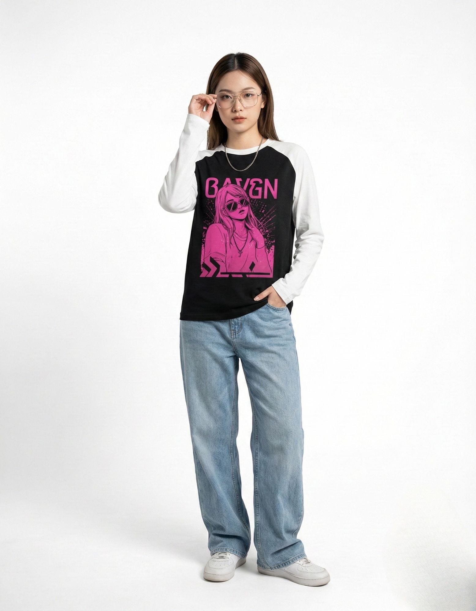 Stylish women's casual outfit showing a black and white raglan sleeve top with a vibrant pink BAYGN graphic.
