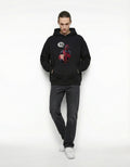 Front view of a man wearing a GENZs Fashion black oversized hoodie with a Deadpool "Best Movie Ever" graphic.