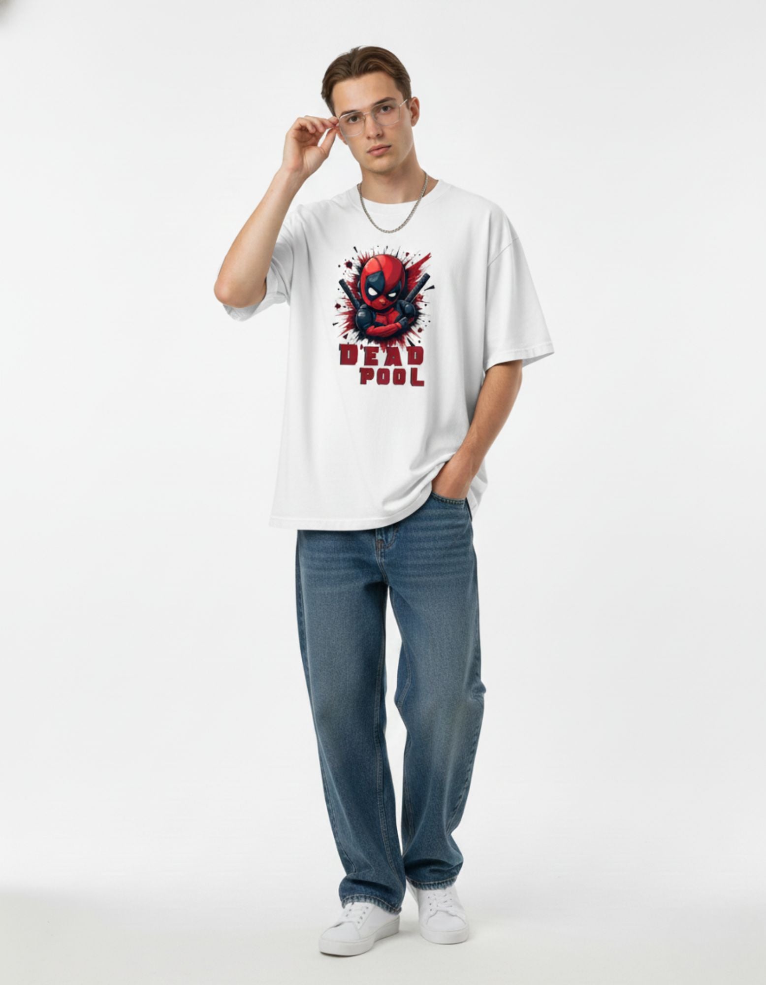 Man wearing white oversized Deadpool graphic printed t-shirt with blue jeans, trendy Marvel merch for men in India.