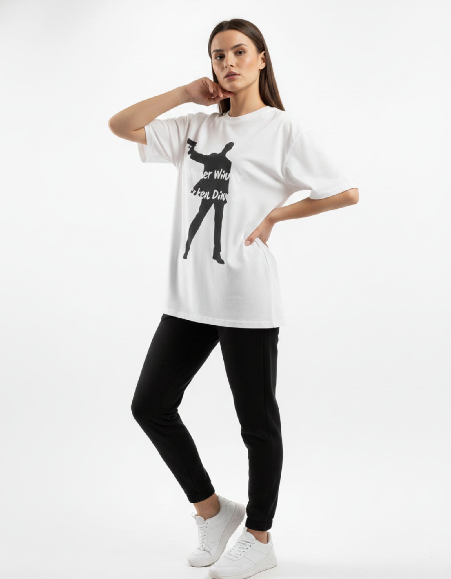 Full-length shot of a woman in a white oversized gaming tee and black joggers, a trending e-sports fan outfit in India.