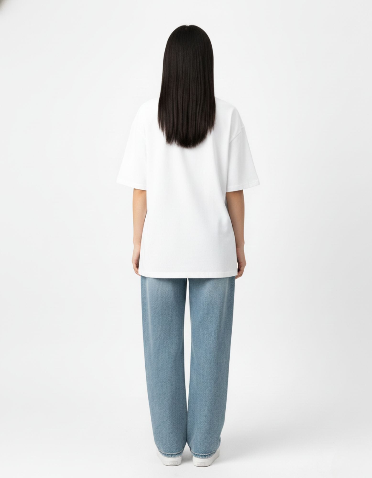 "Back view of a male model wearing a high-quality white oversized streetwear t-shirt by GENZs Fashion."