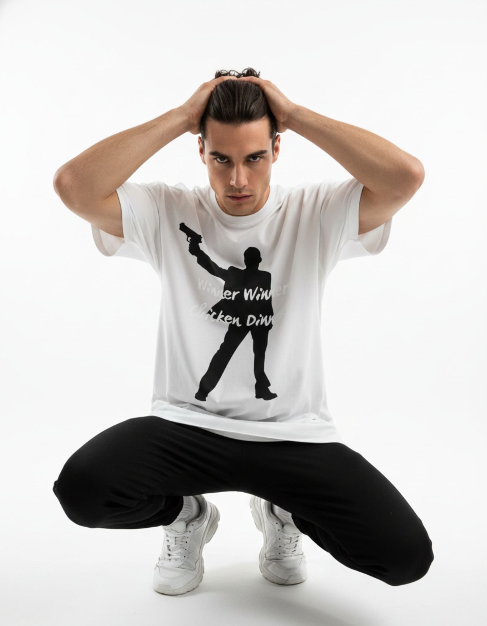 Male model in a squatting pose wearing a GENZs Fashion white oversized gaming t-shirt, showcasing the baggy streetwear silhouette.
