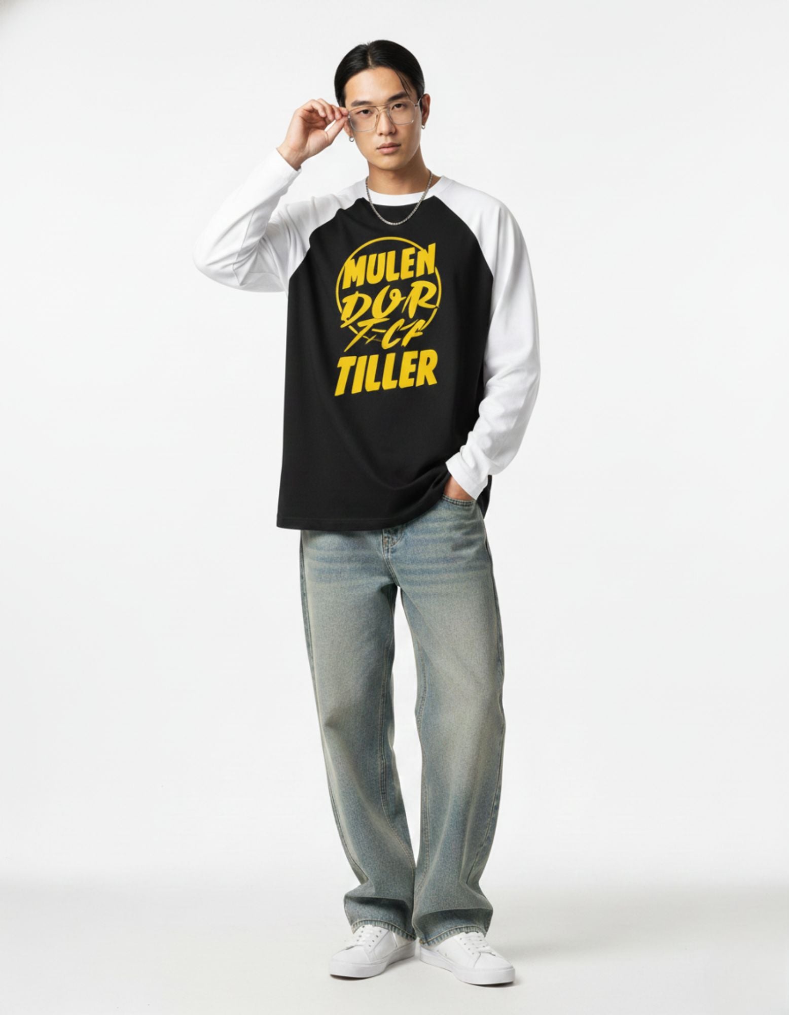 Male model with glasses wearing GENZs Fashion raglan sleeve graphic tee, showcasing a smart-casual streetwear aesthetic.