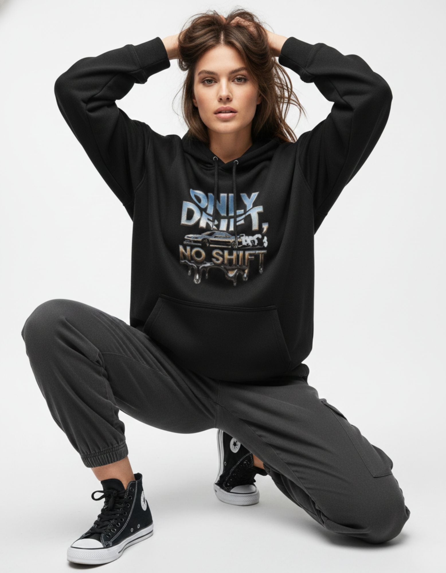 Female model wearing an oversized black hoodie with a JDM car graphic, styled for a trendy and comfortable Gen Z streetwear outfit.