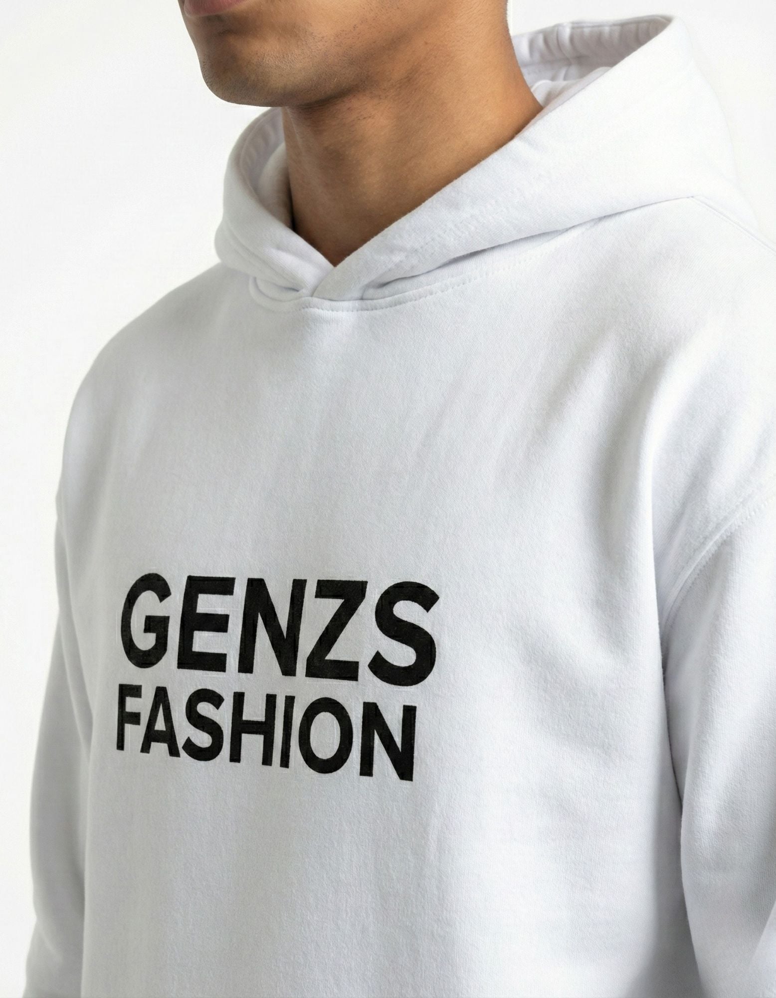 Close-up of black GENZs FASHION text logo on a premium white cotton streetwear hoodie.