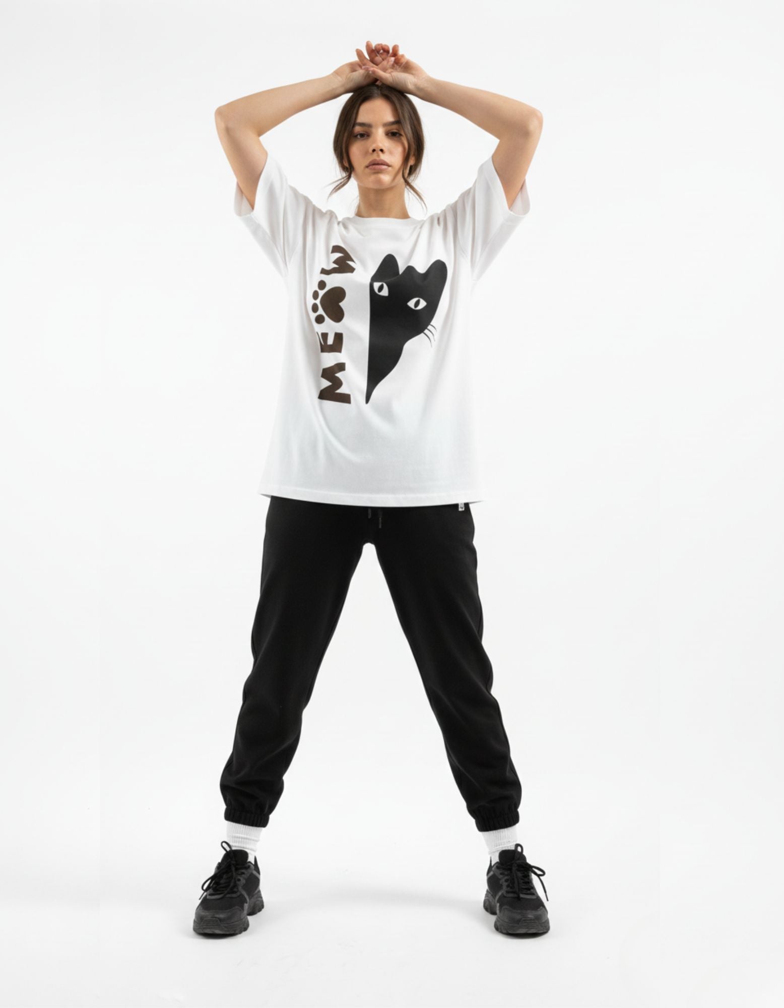 Women's white oversized t-shirt by GENZs Fashion featuring a minimalist black cat graphic, styled for modern Indian street fashion.
