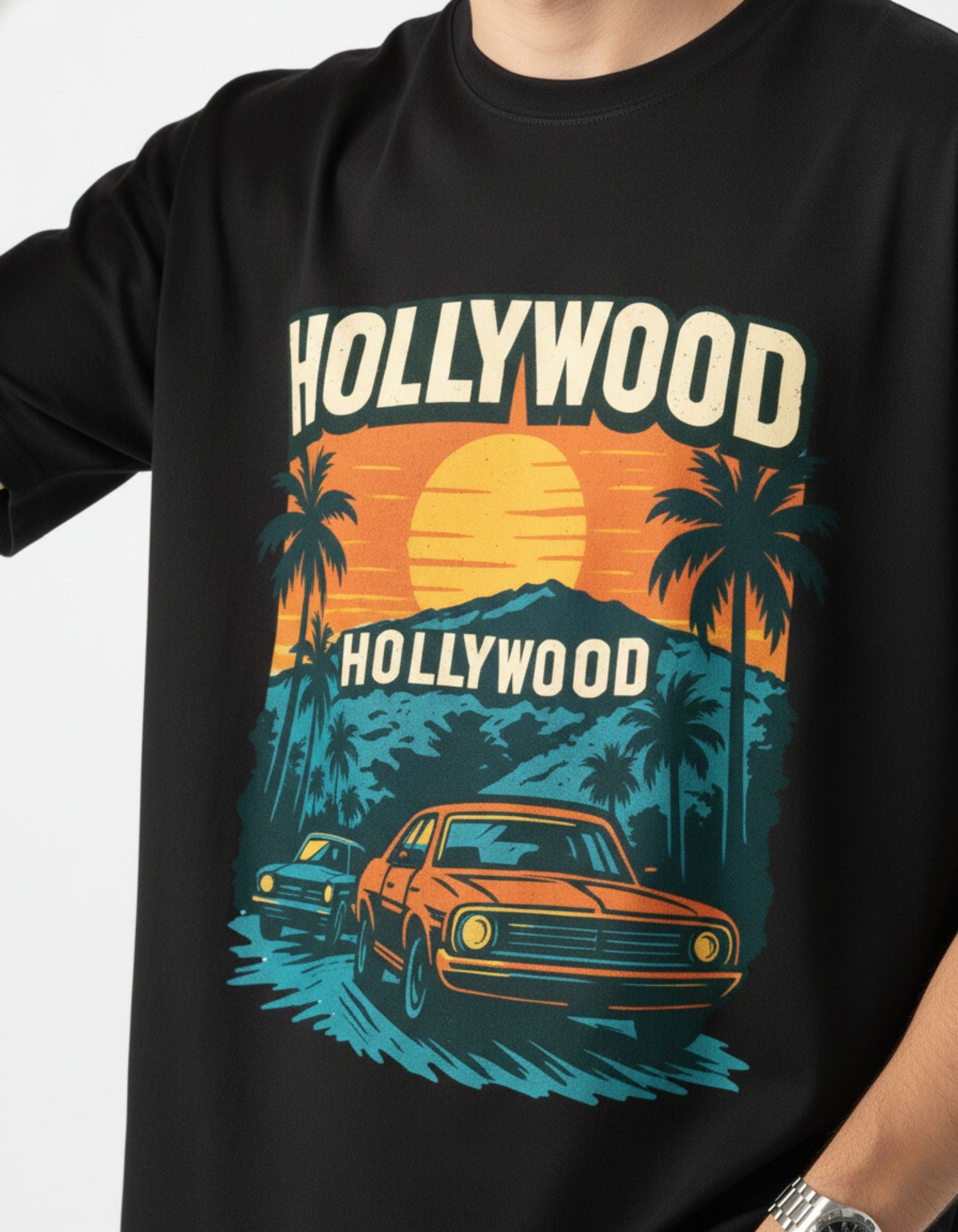 Close-up of retro Hollywood sunset graphic print on black oversized t-shirt.