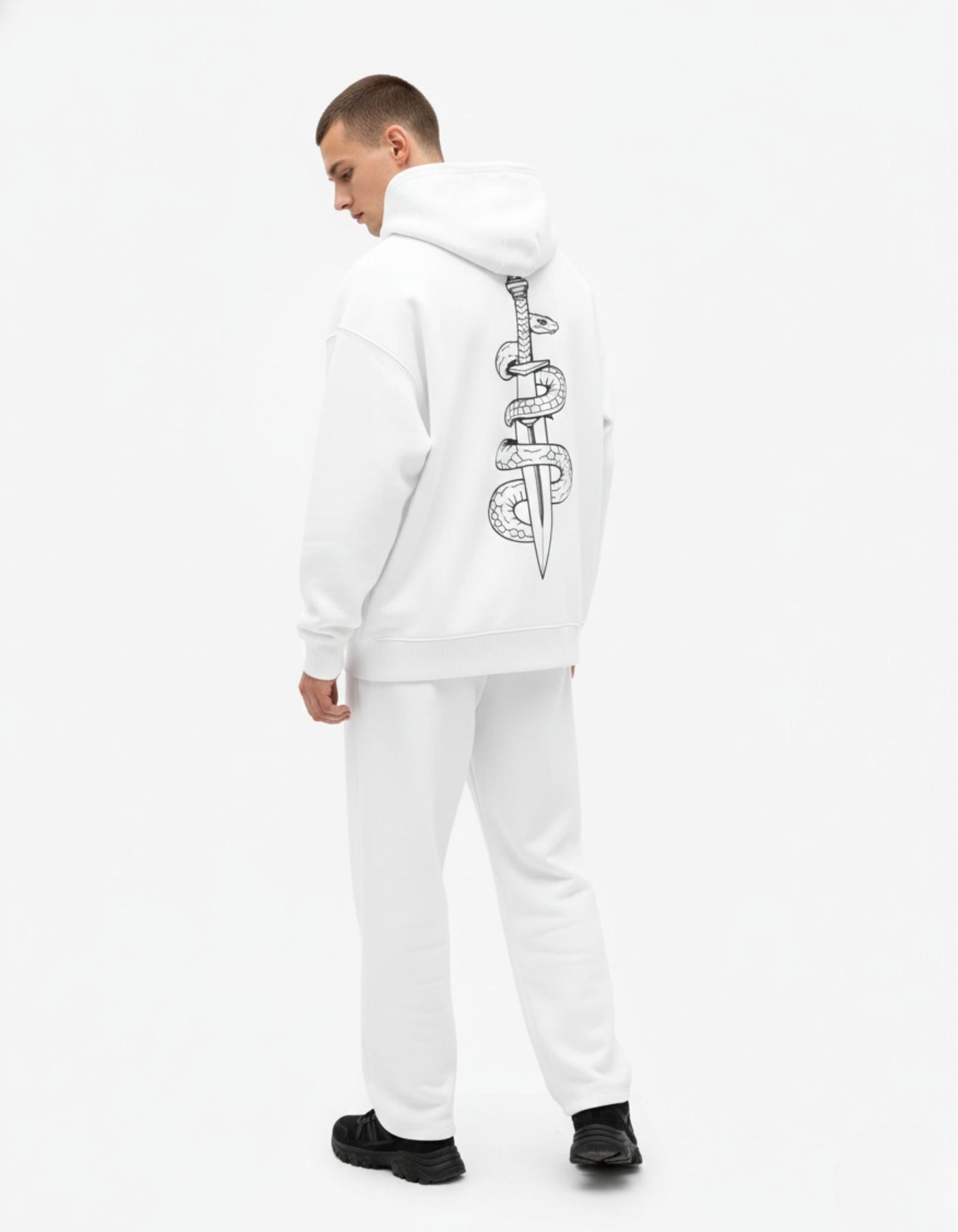 Male model showcasing the back of the white snake and dagger graphic hoodie, a staple for Gen Z luxury streetwear.