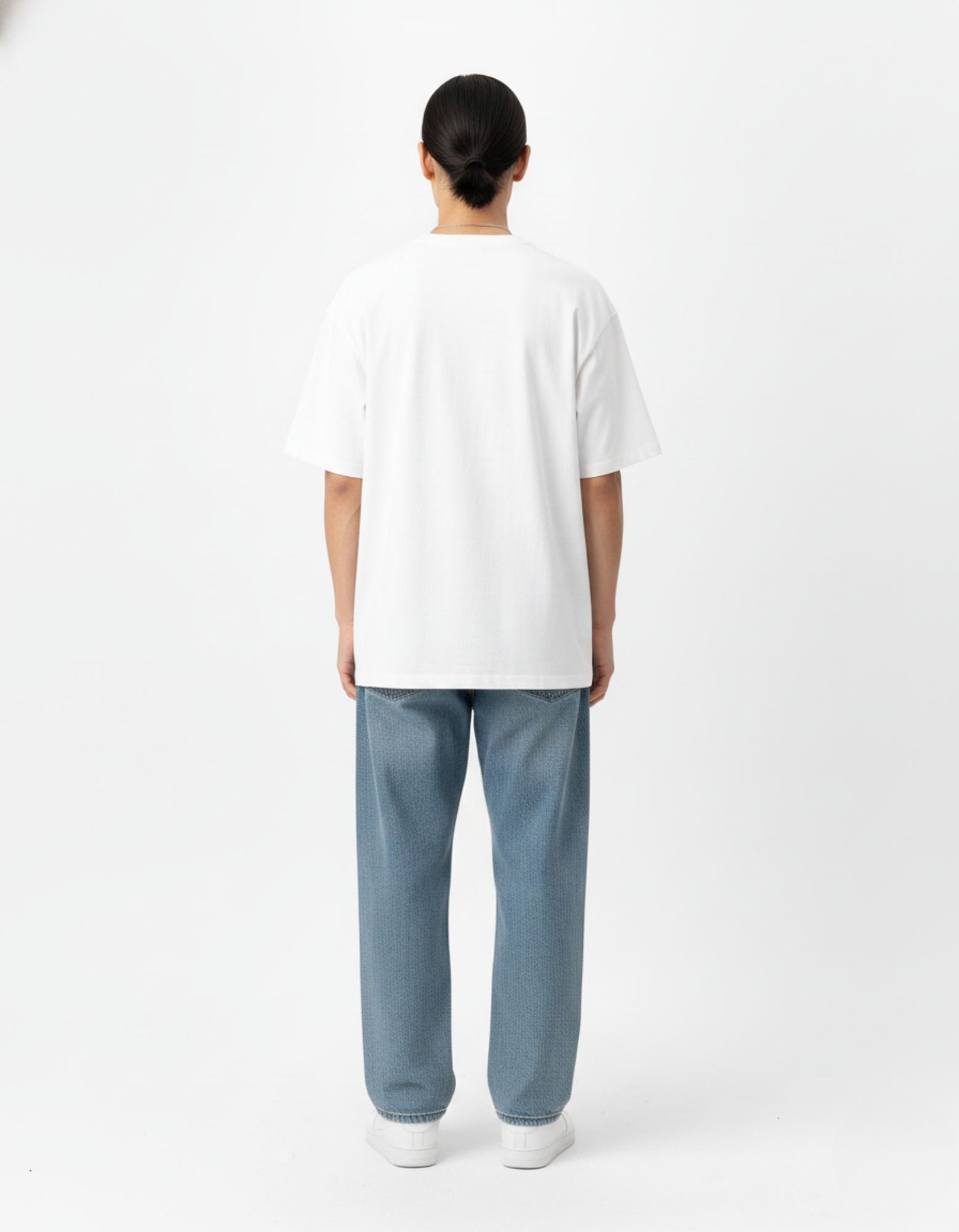 "Side view profile of a model wearing an oversized anime streetwear tee and blue baggy jeans from GENZs Fashion."