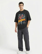 Male model wearing a black GENZs Fashion baggy-fit t-shirt with a detailed zombie horror illustration, perfect for the edgy urban fashion trend in Bangalore and Delhi.