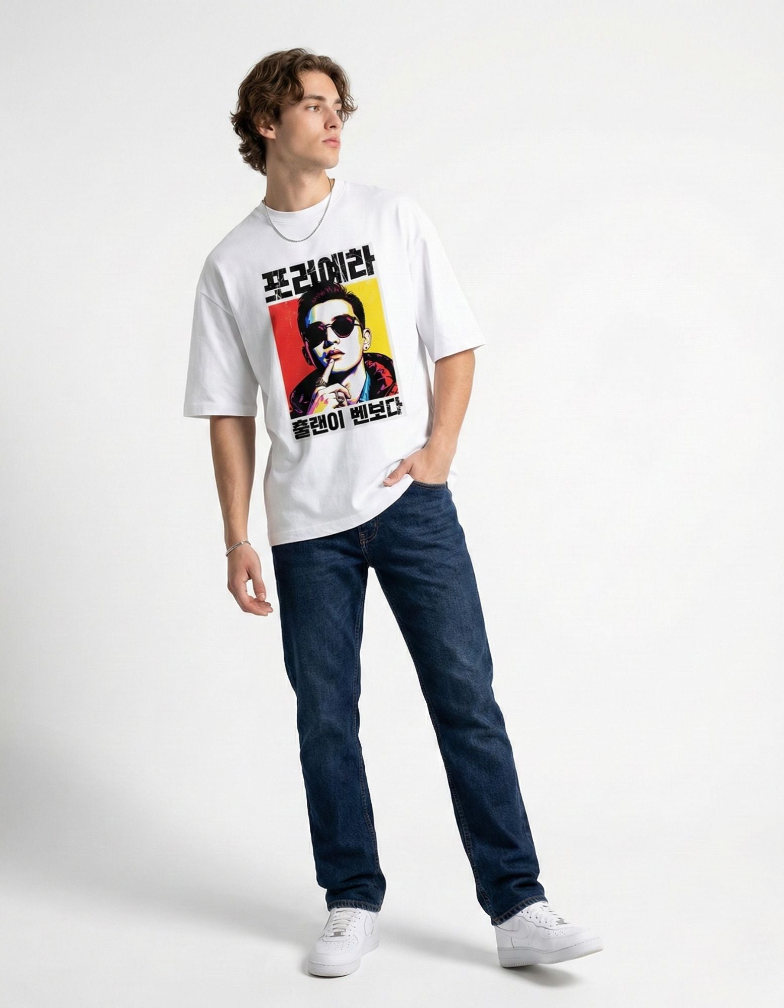 "Model wearing a white drop shoulder t-shirt with vibrant Korean print, trendy oversized fit for men."