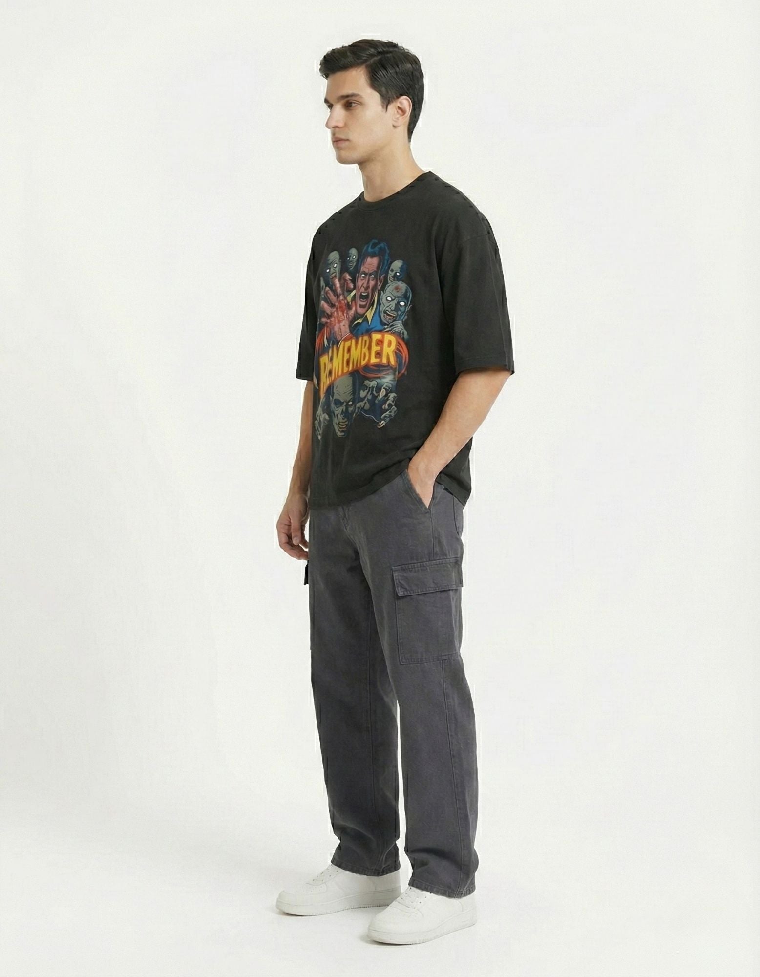 Side view of a male model in an oversized black graphic t-shirt, demonstrating the heavy-weight fabric drape and comfortable silhouette for daily wear.