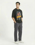 Full-length shot of a man in a black graphic tee and grey cargo pants, a trending "Street Style" outfit for Indian youth.