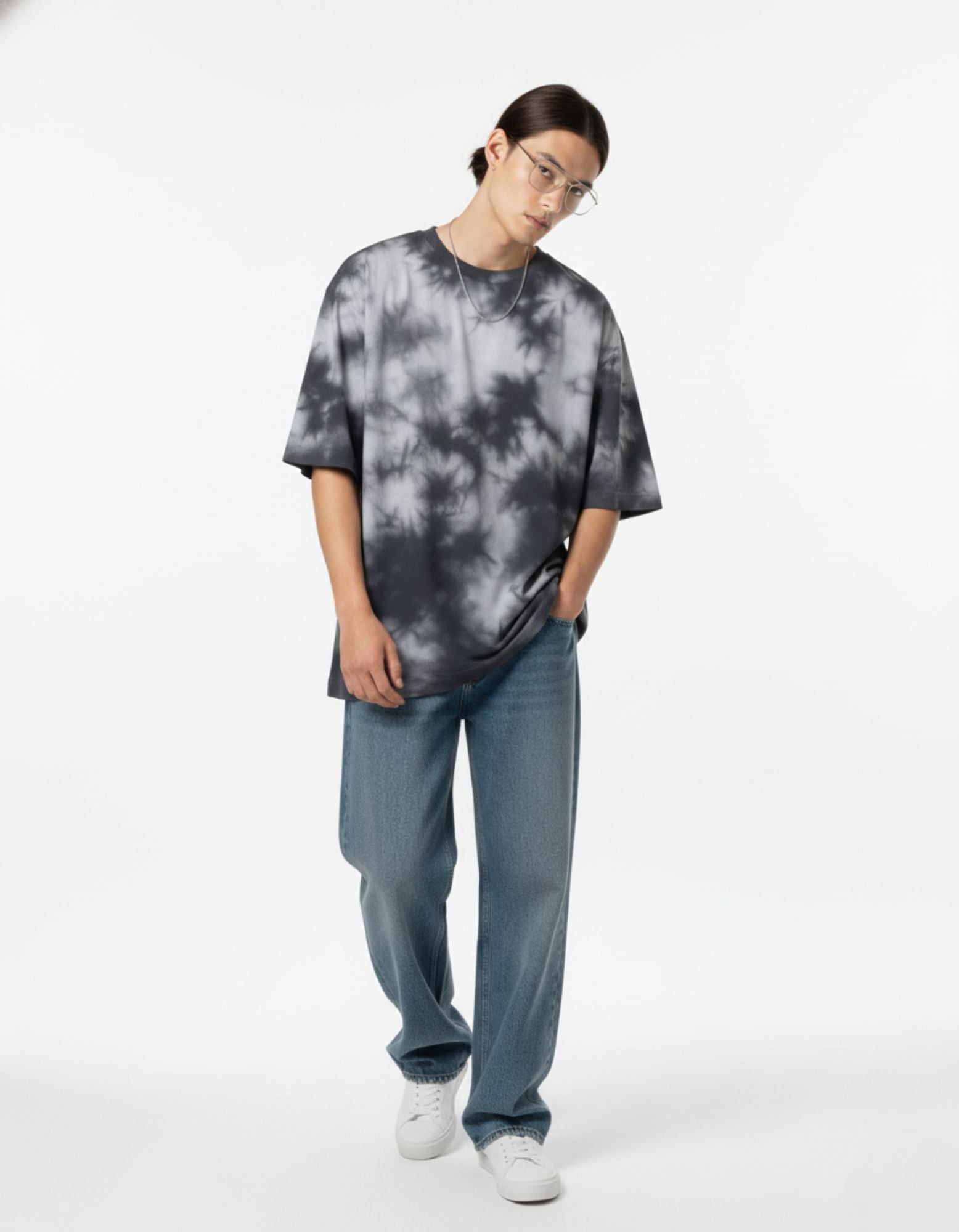 "Male model in an urban gray and black tie-dye oversized t-shirt, perfect for Gen-Z streetwear trends in India."