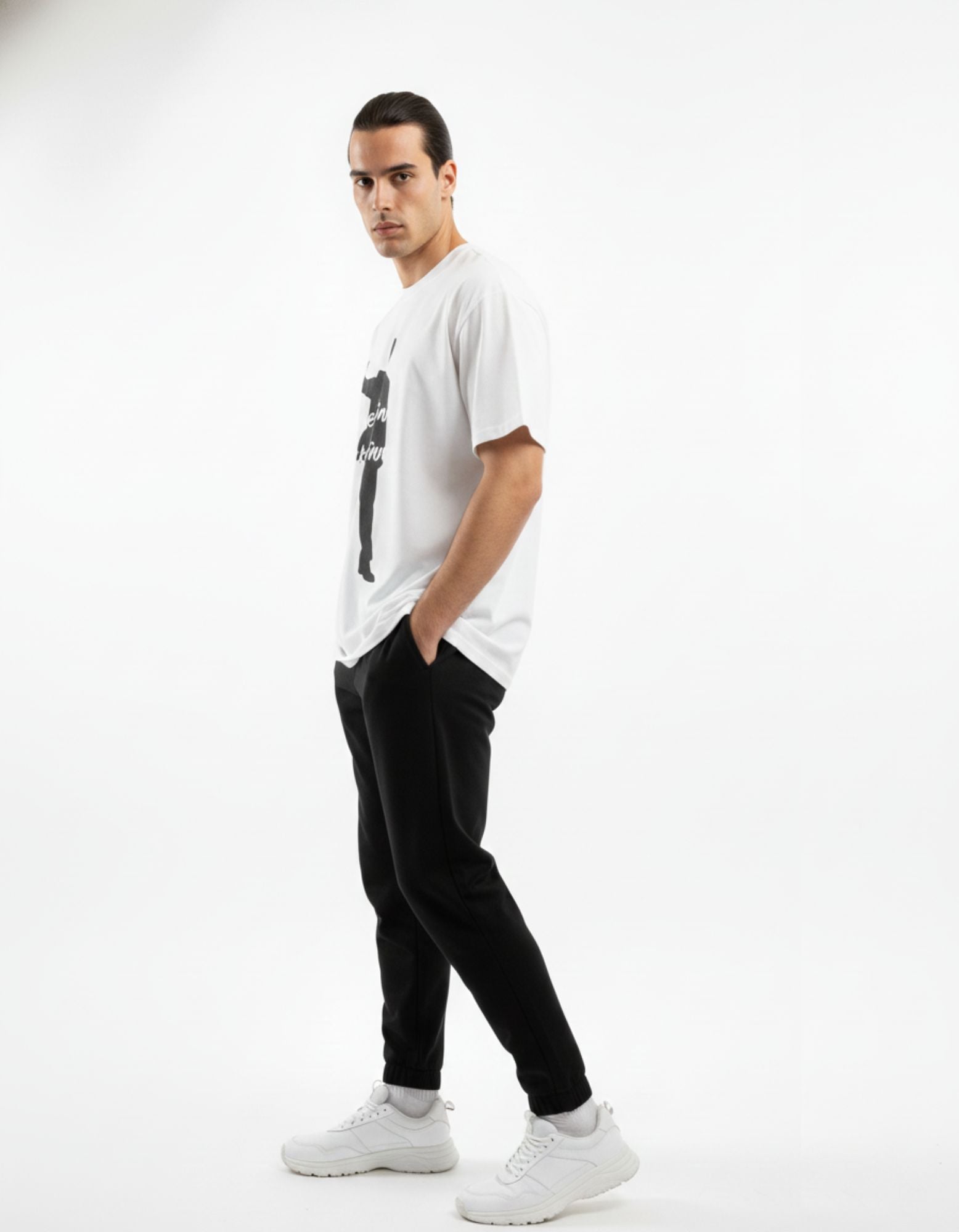 Side profile of a male model in a white baggy gaming tee, demonstrating the trendy drop-shoulder streetwear fit.