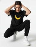 Male model in a GENZs Fashion black oversized t-shirt with a high-contrast yellow banana graphic.