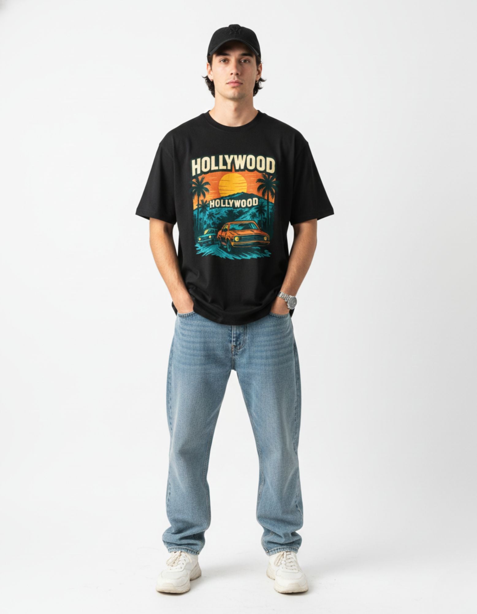 Man wearing black oversized t-shirt with retro Hollywood car graphic, streetwear India.
