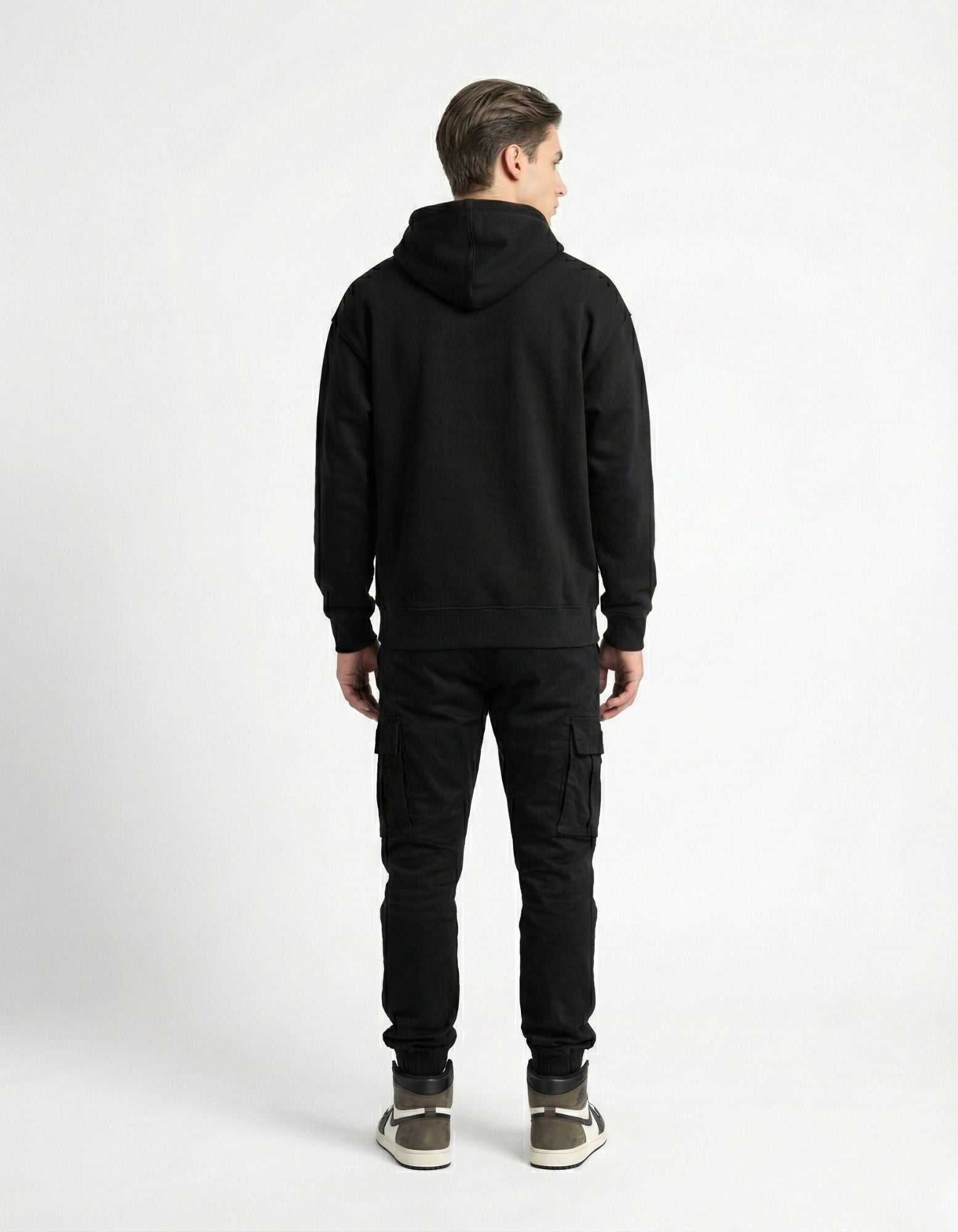 Back view of a man in a black GENZs Fashion hoodie, showcasing the structured fit and streetwear aesthetic.