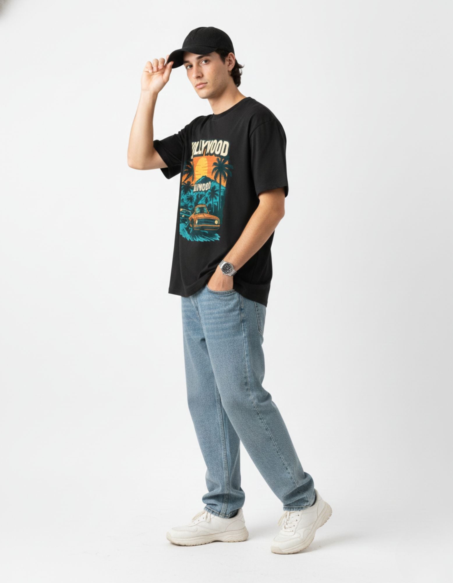 Side view of woman in black oversized streetwear tee with drop shoulder fit.