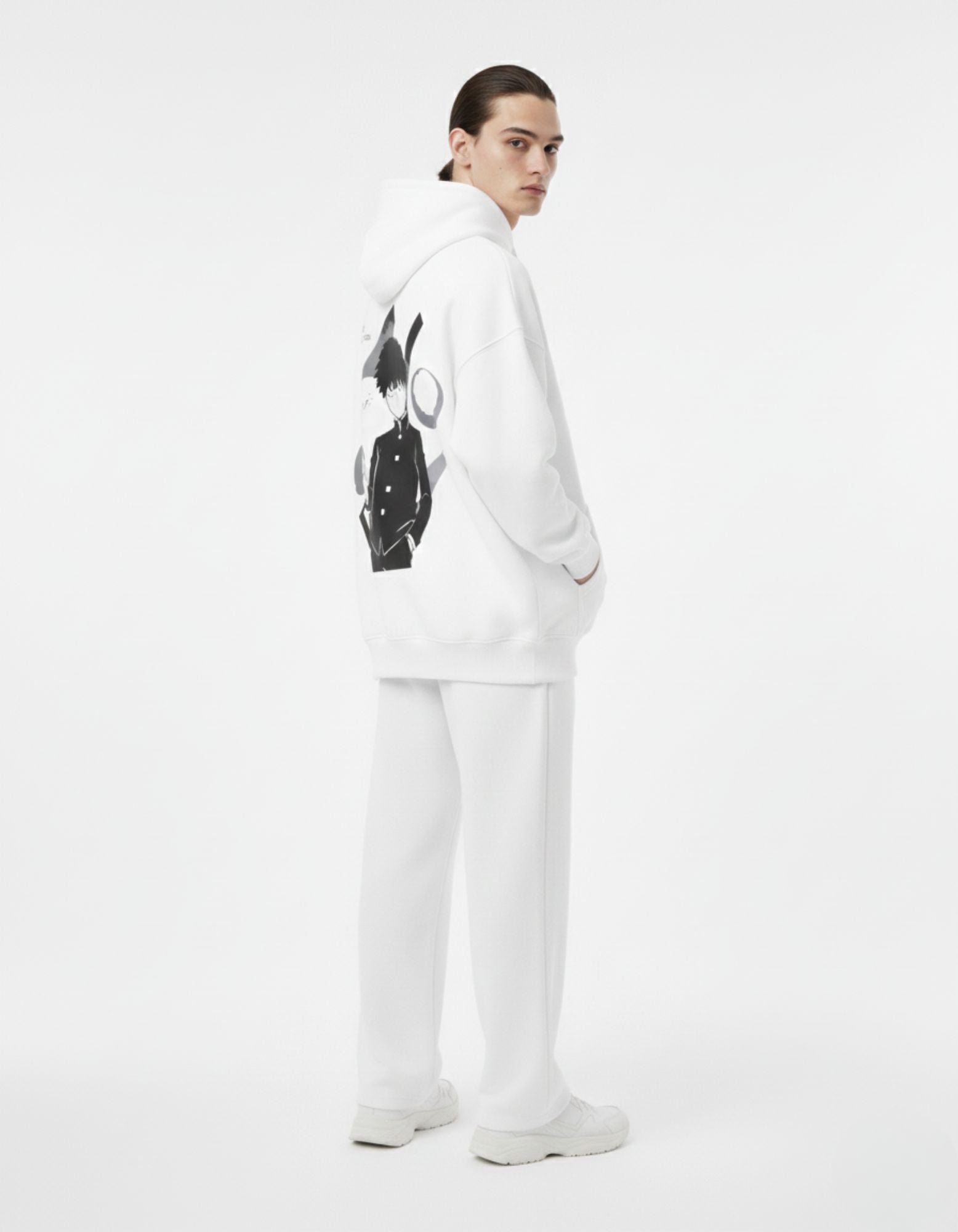 Male model wearing white Mob Psycho 100 anime streetwear hoodie, oversized fit with back graphic print.
