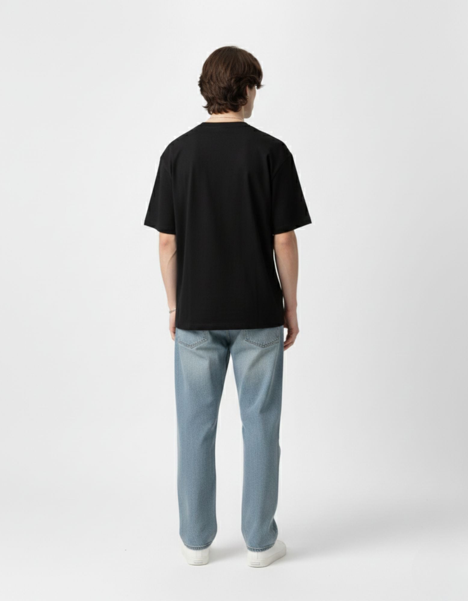 Back view of a men’s black oversized drop-shoulder t-shirt, emphasizing the baggy silhouette popular in Indian streetwear.