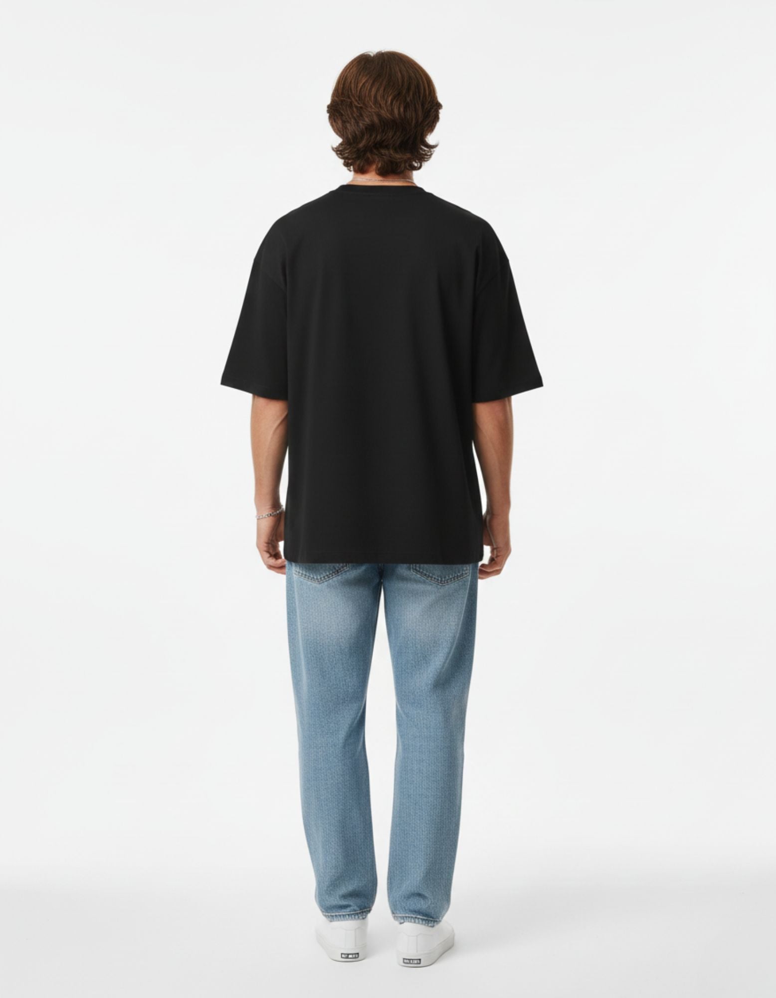 Side profile of the '704' graphic tee, showing the sleeve length and oversized streetwear fit for men.