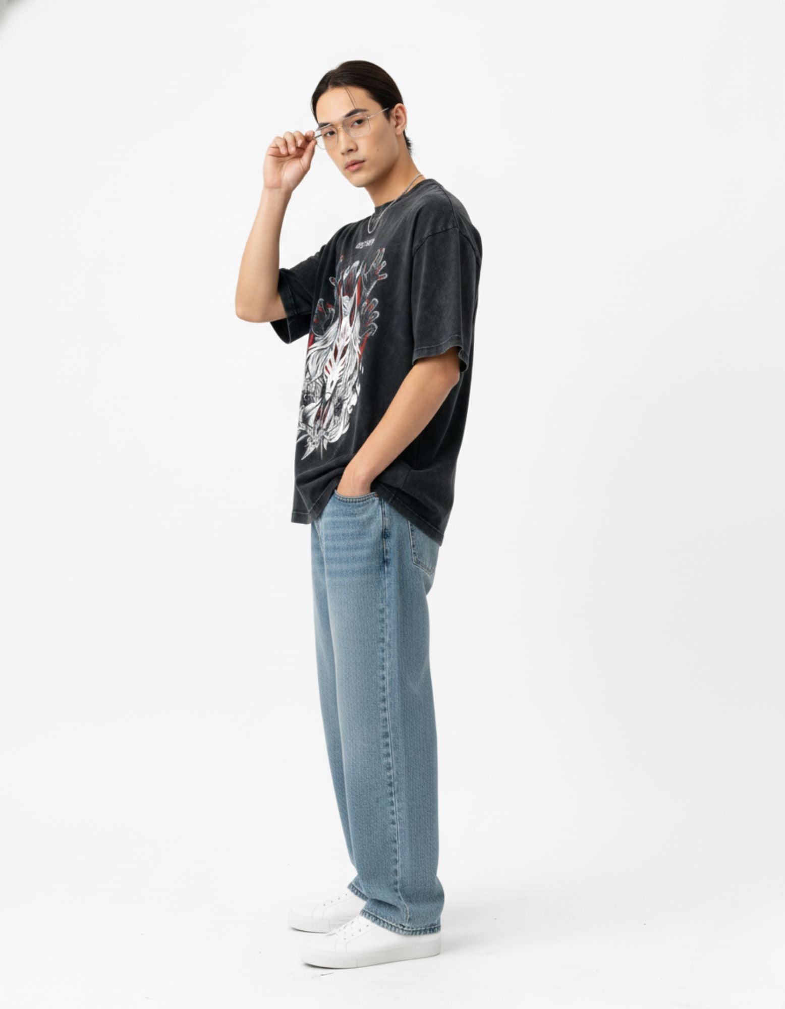 Side view of a male model wearing the oversized Kitsune mask graphic tee in vintage charcoal for a boxy streetwear fit.