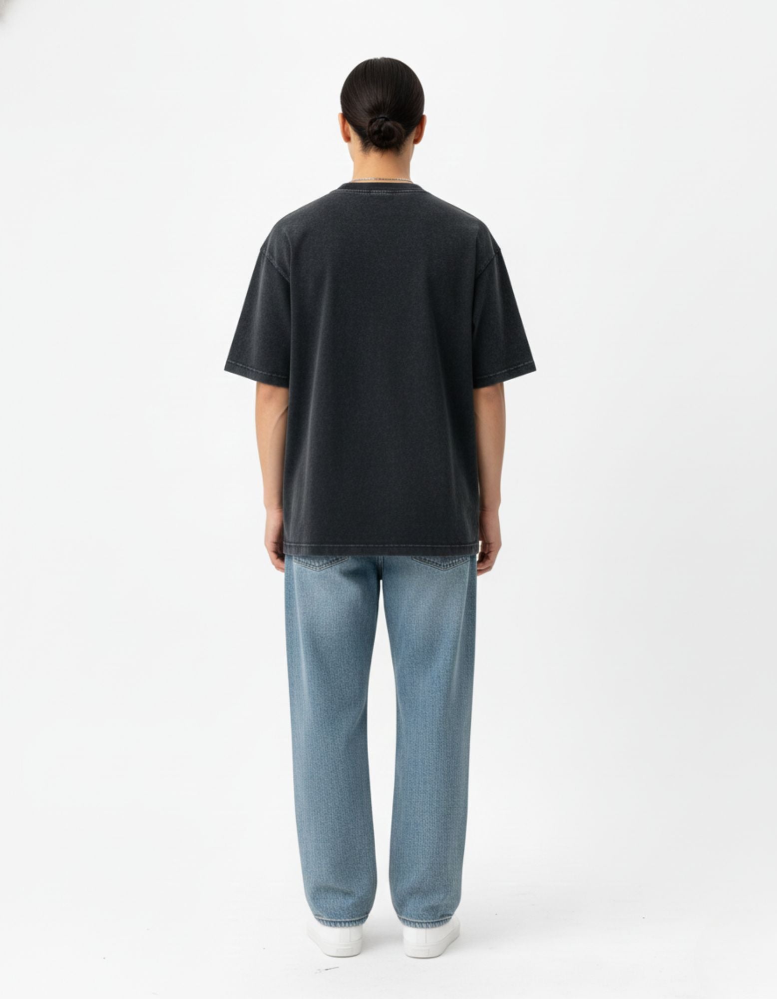 Back view of a men's oversized charcoal streetwear t-shirt showing the relaxed, wide-cut urban fit.